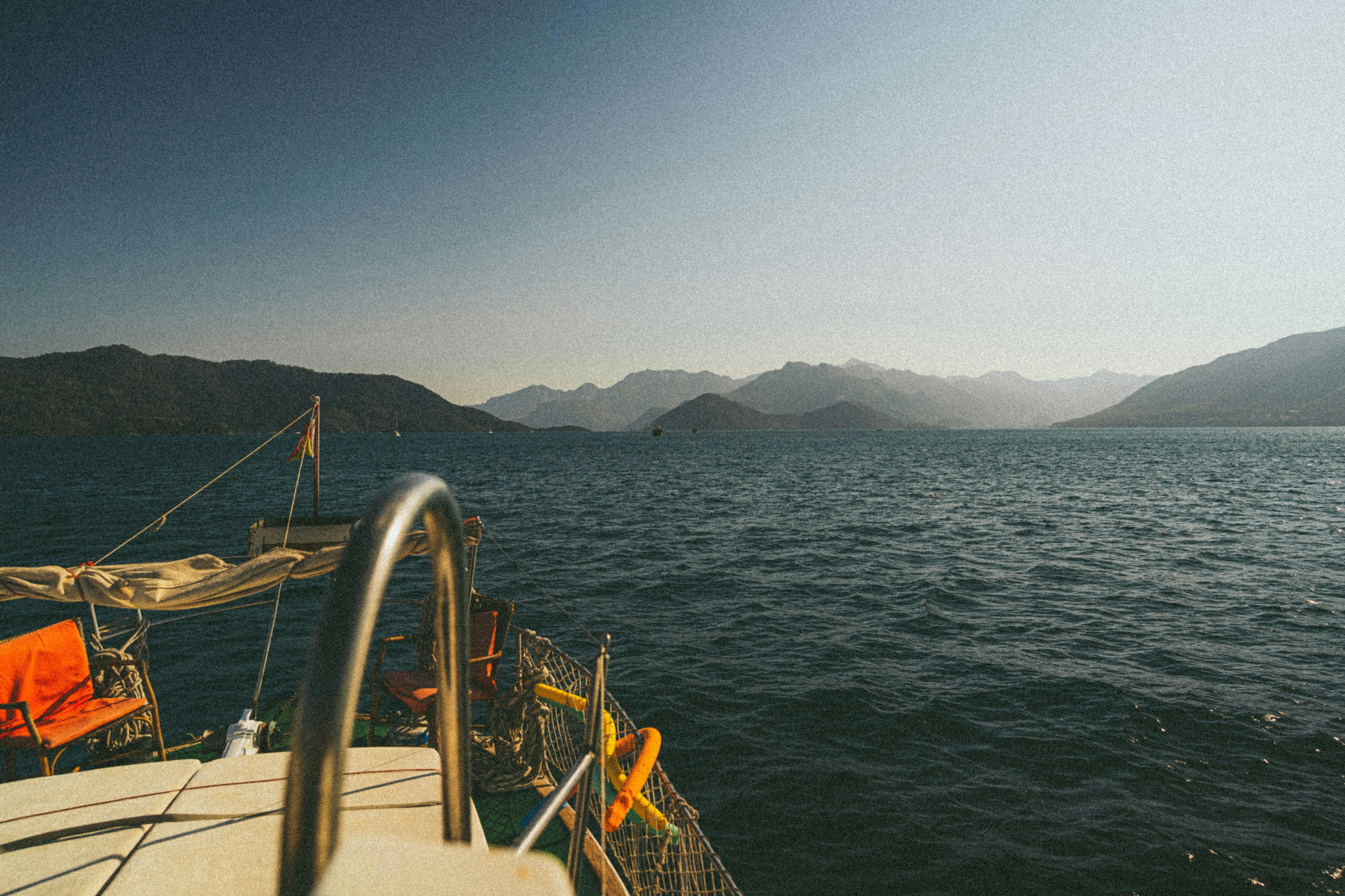 Sailing on the sea towards distant mountains