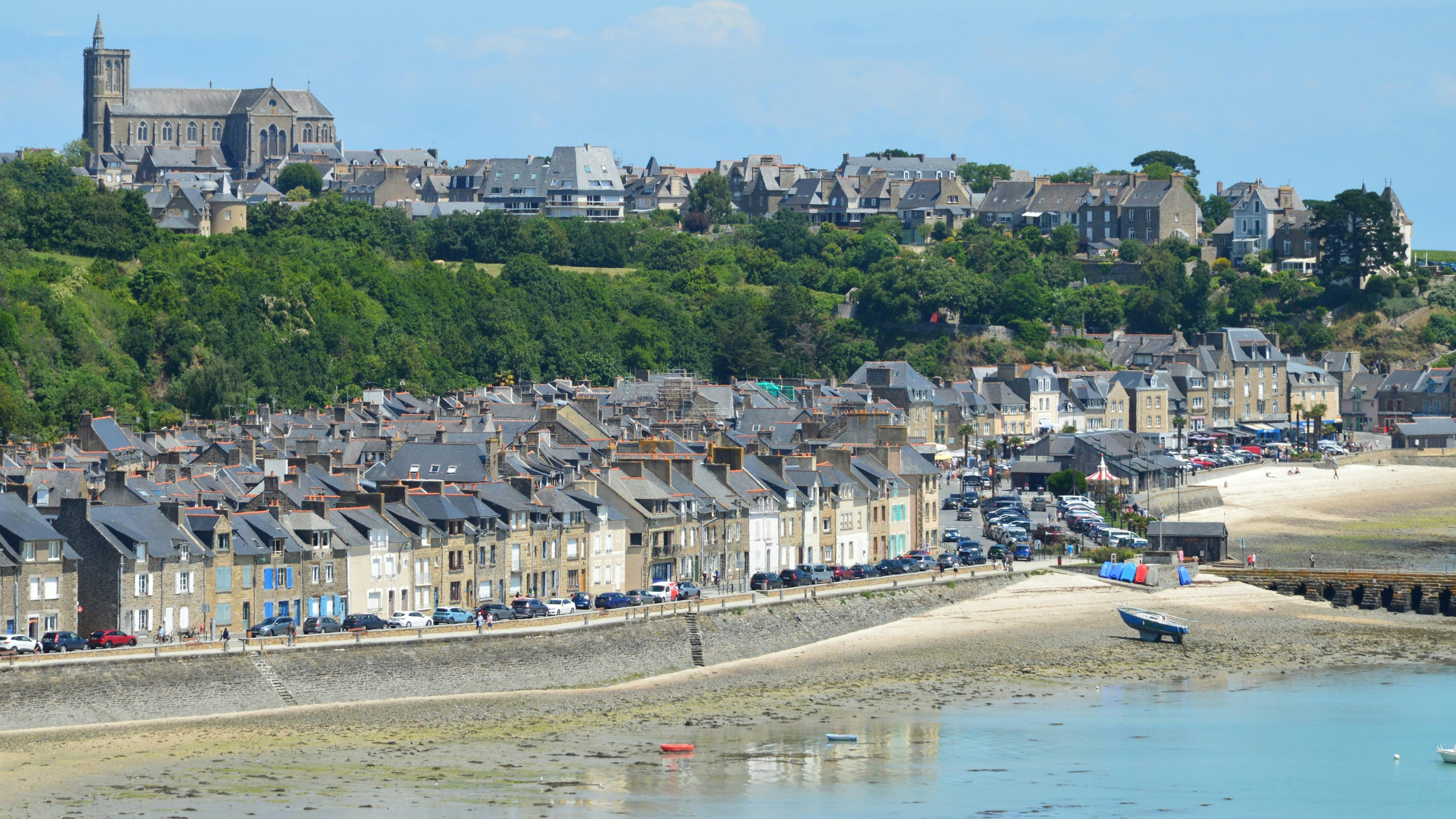 Coastal town with historic buildings and a church.