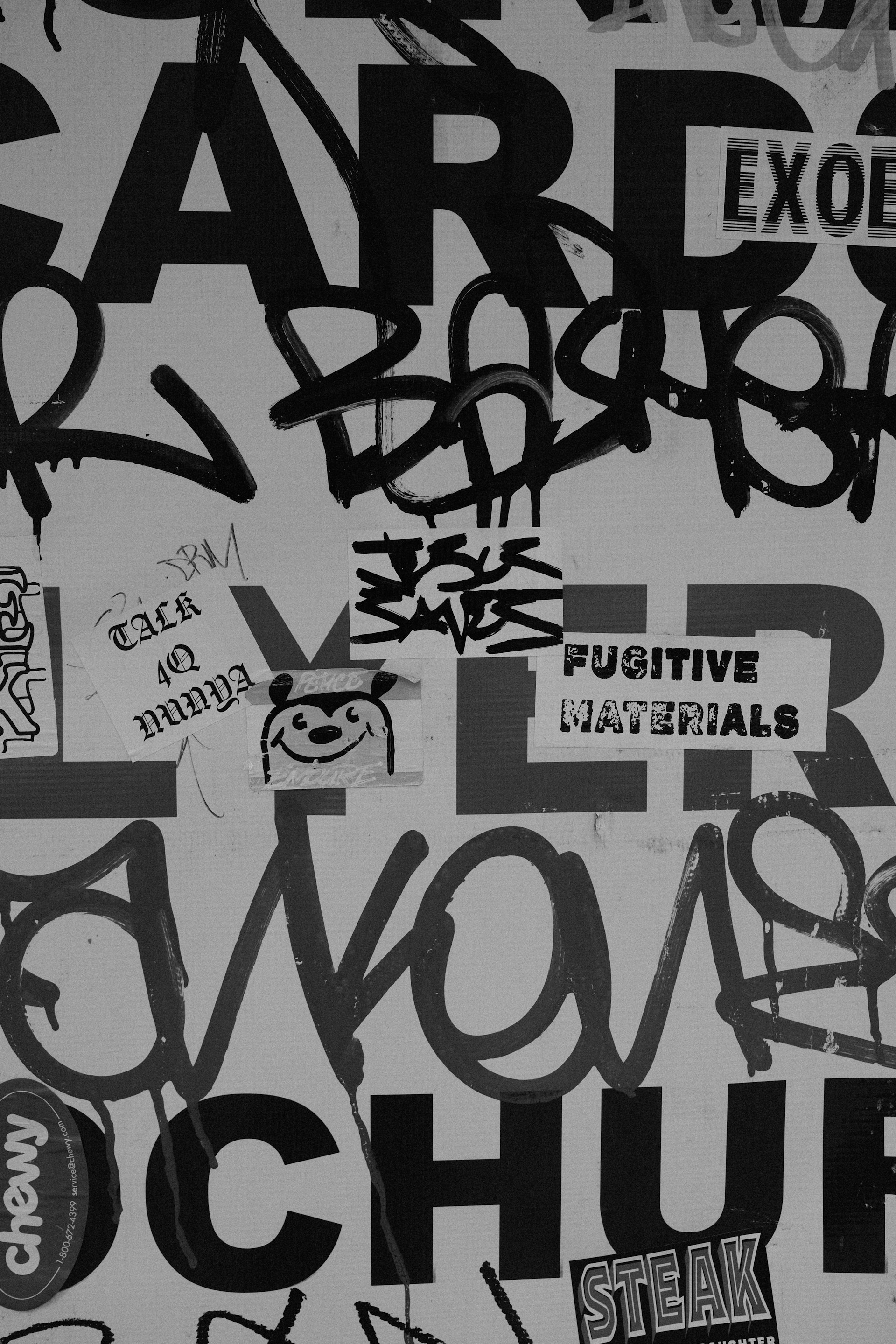 Graffiti and stickers cover a wall surface.