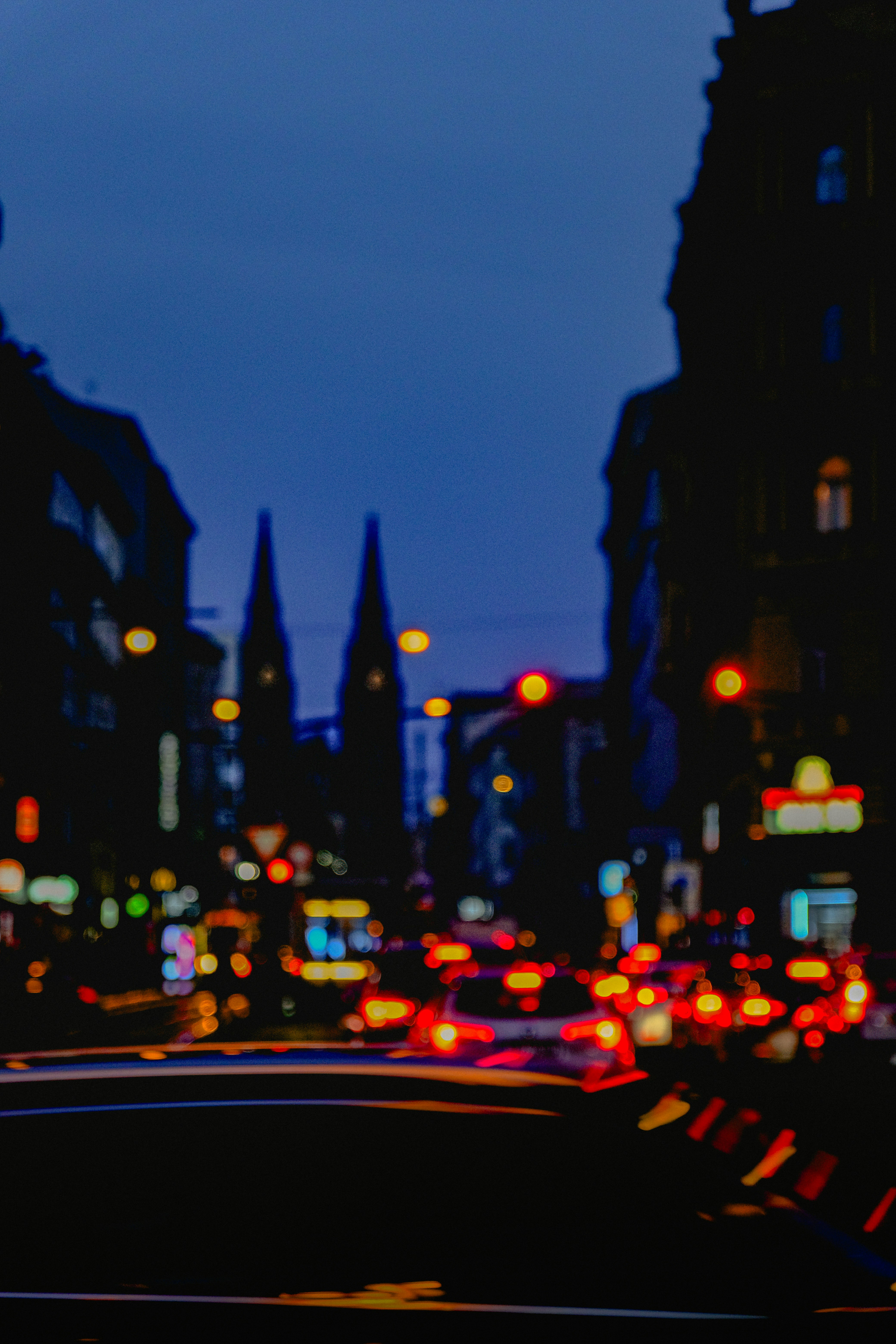 Blurred city street at night with traffic lights.