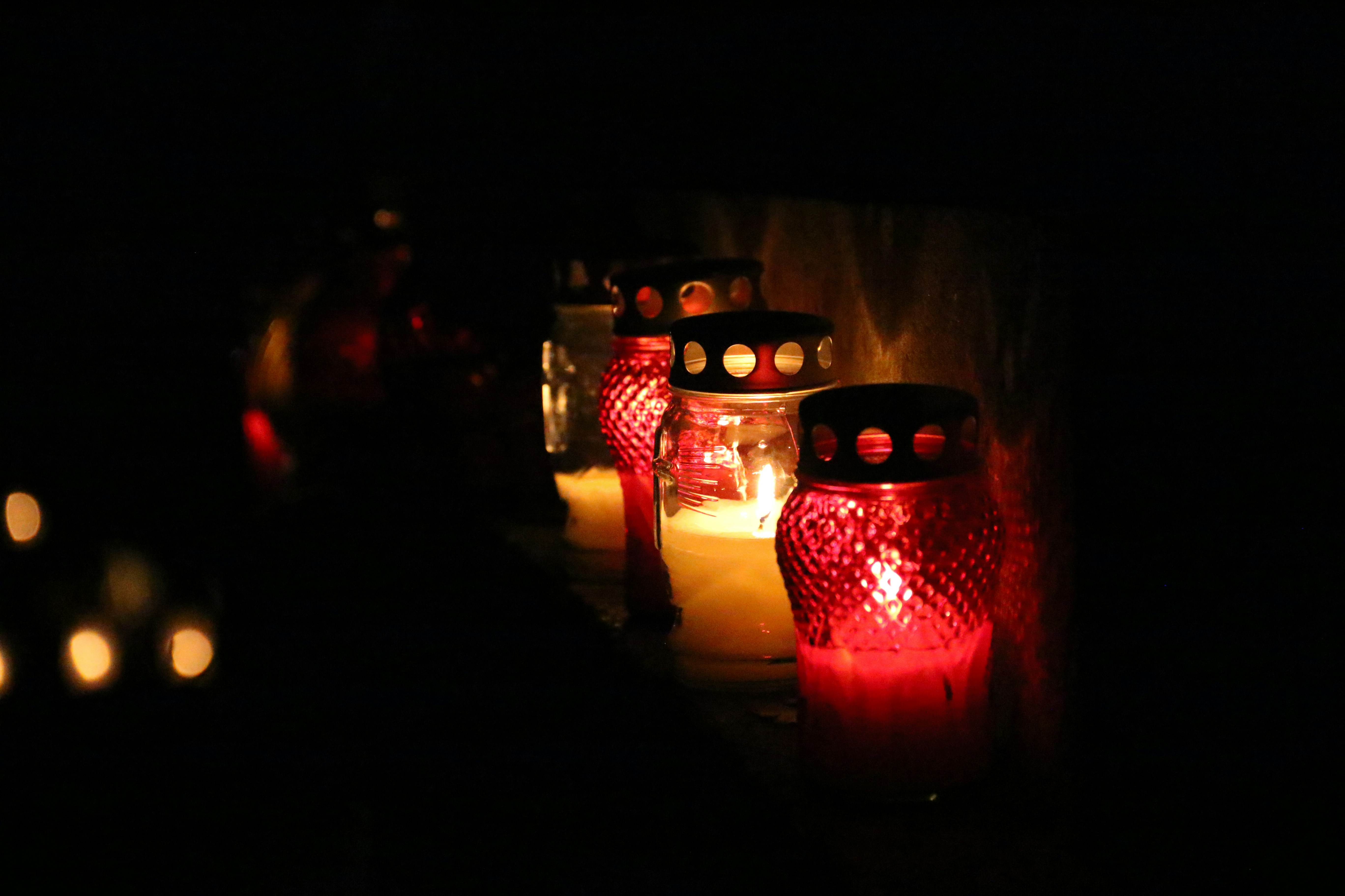 Several lit candles in dark setting