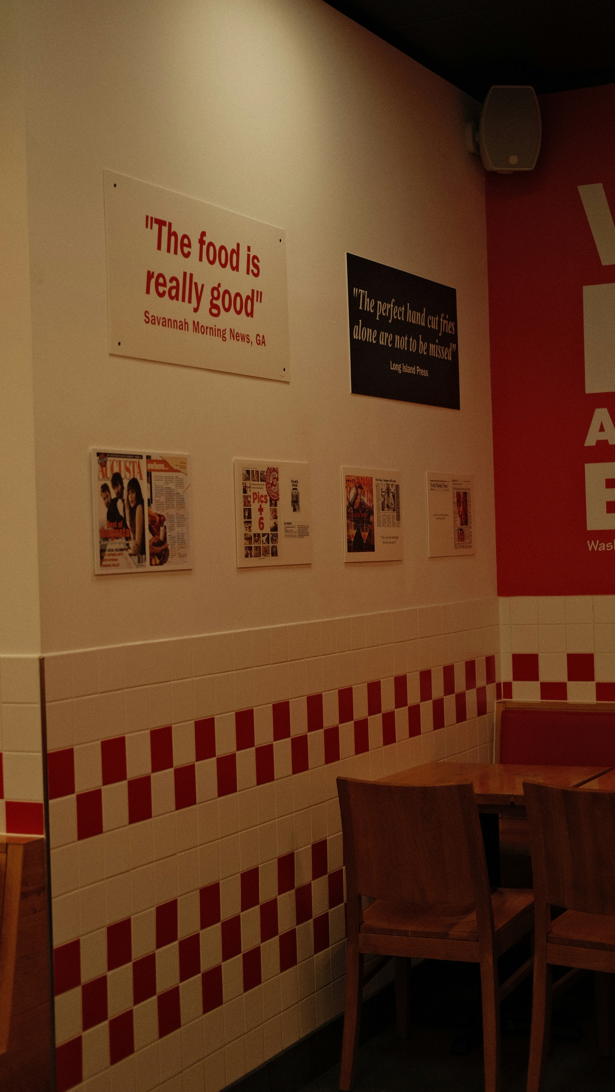 Restaurant wall with quotes and checkered pattern.