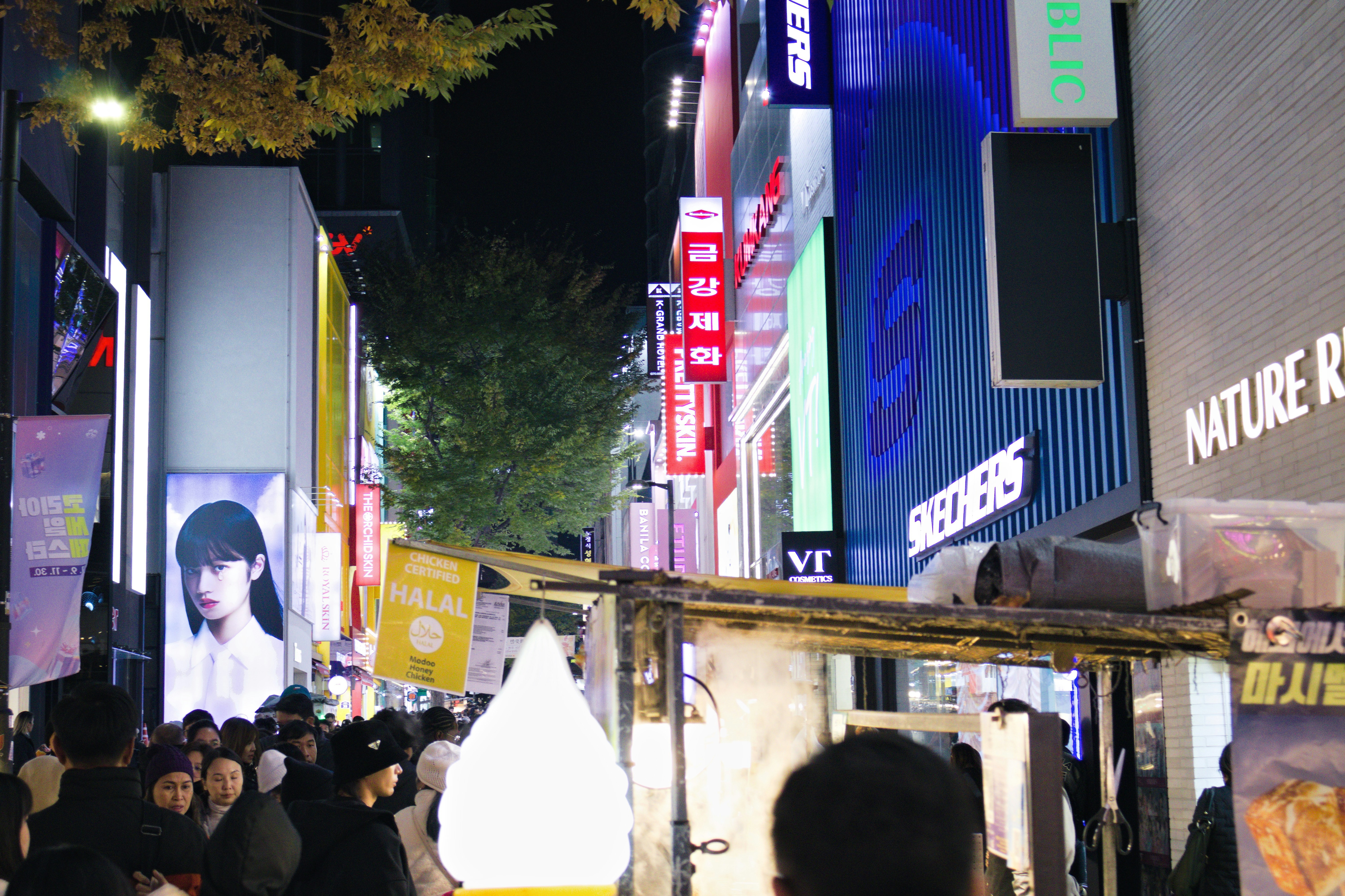 Busy street with glowing signs at night