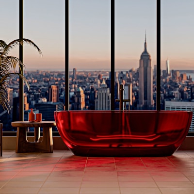 Modern red bathtub with city view at sunset
