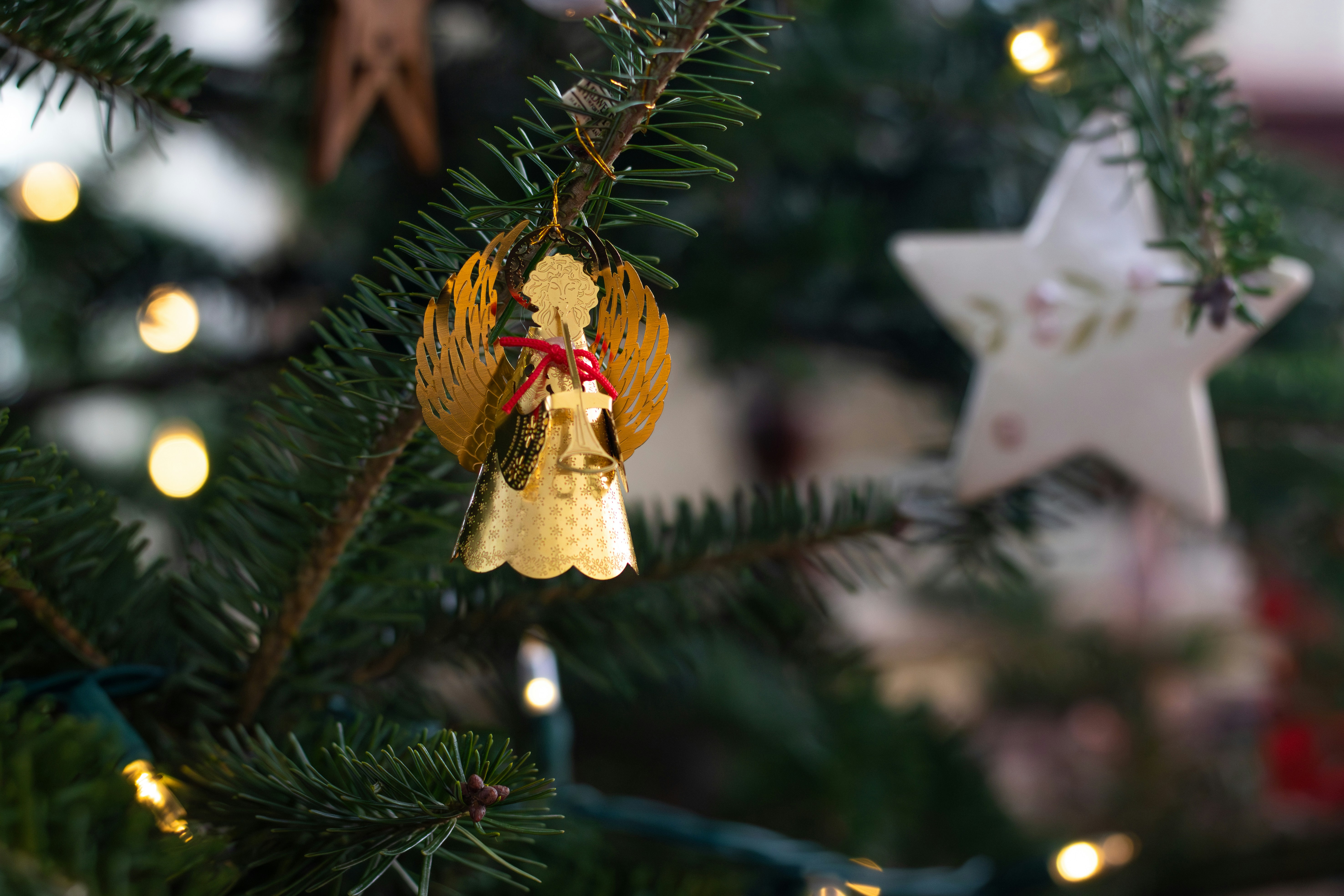 Christmas angel ornament on a decorated tree