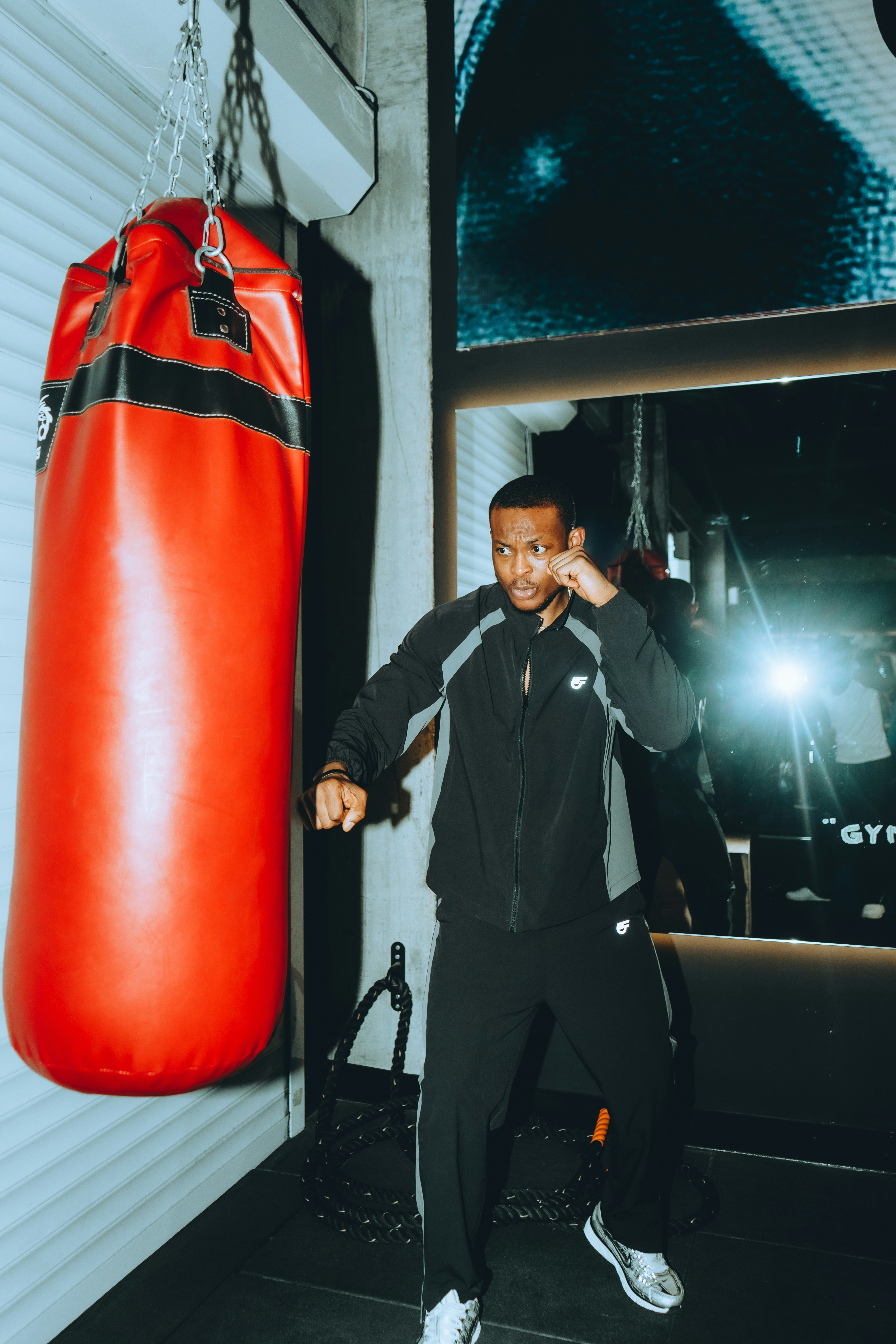Man boxing with a red punching bag