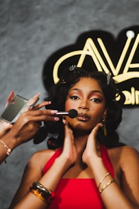 Woman applying makeup with brush and mirror