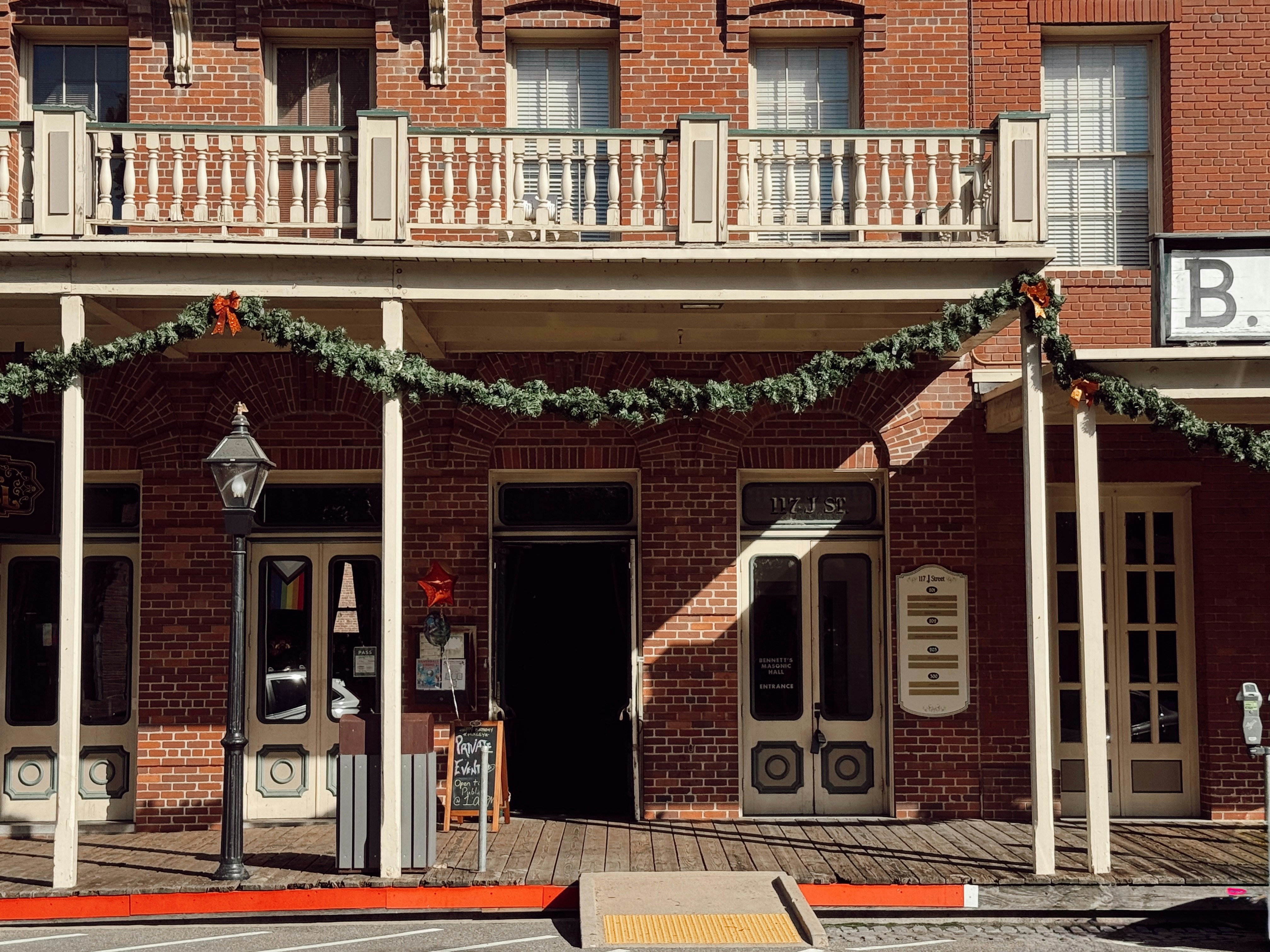 Old brick building with festive holiday garland decorations
