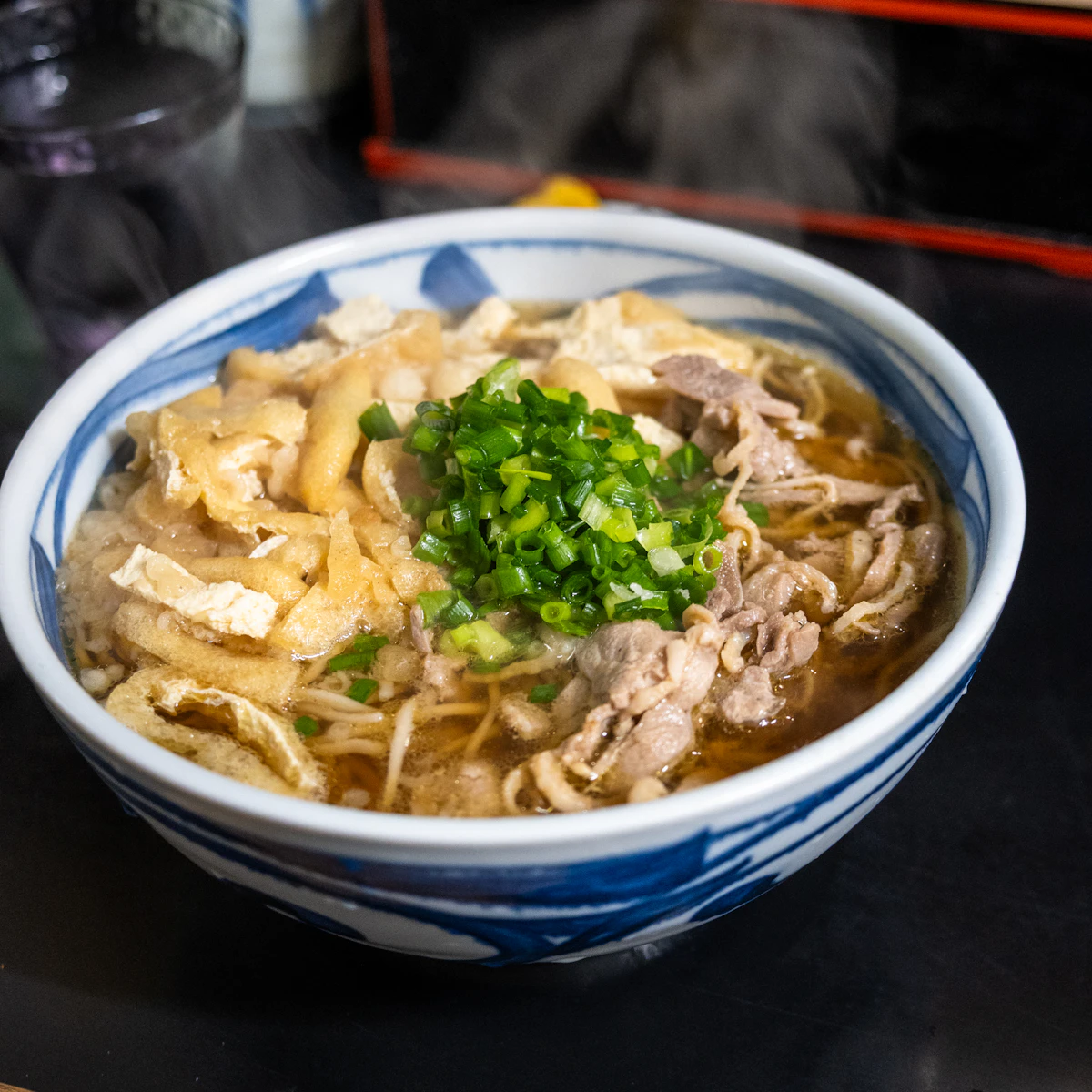 Steaming udon noodles with beef and tofu