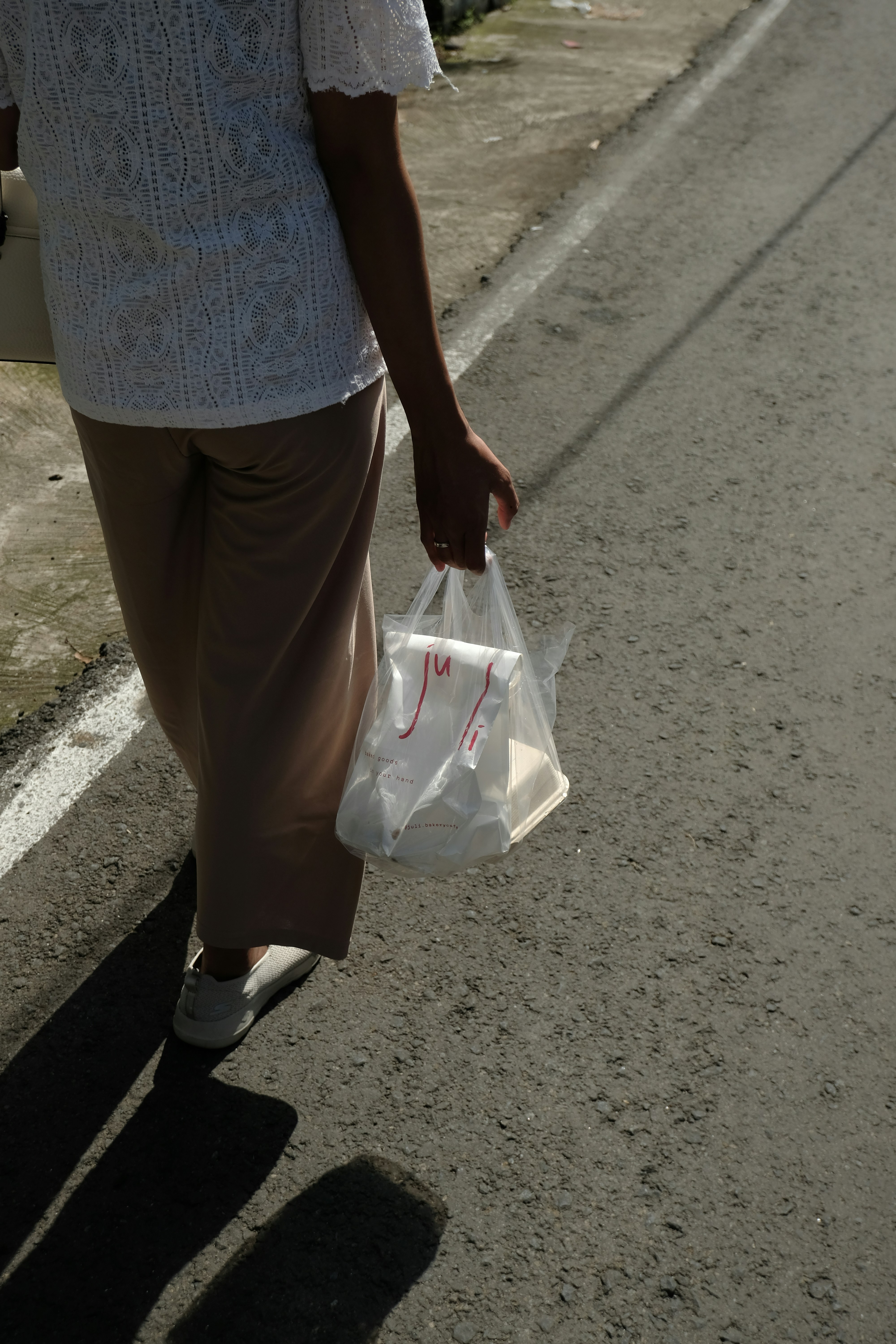 Person walking with a plastic bag