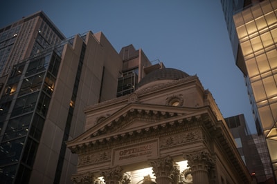 Classical building facade between modern skyscrapers