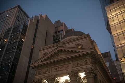 Classical building facade between modern skyscrapers