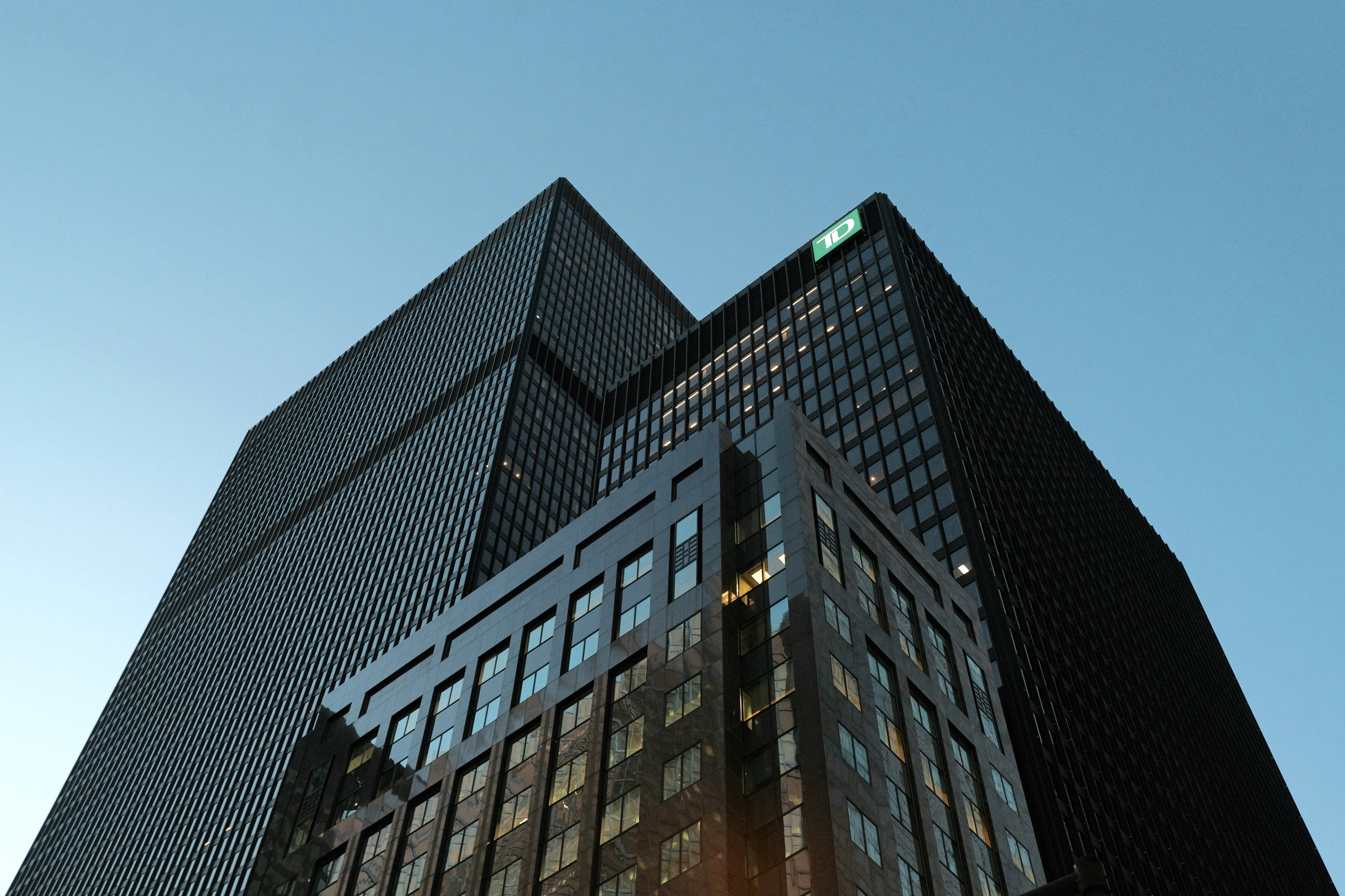 modern glass corporate skyscraper financial district dusk