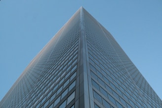 Modern skyscraper viewed from below against clear sky