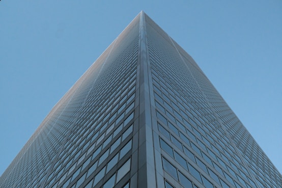Modern skyscraper viewed from below against clear sky