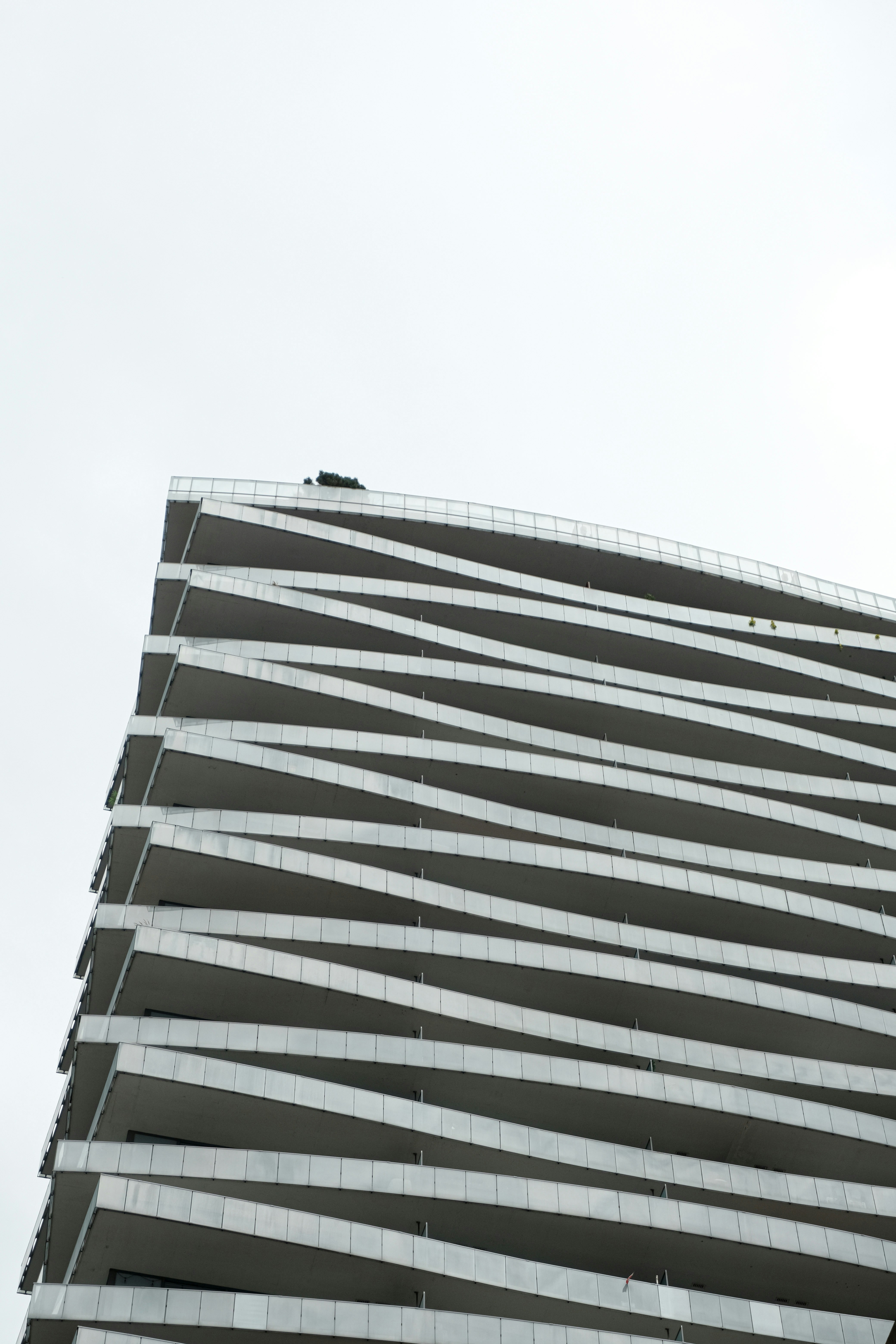 Modern building with unique wavy balconies against sky