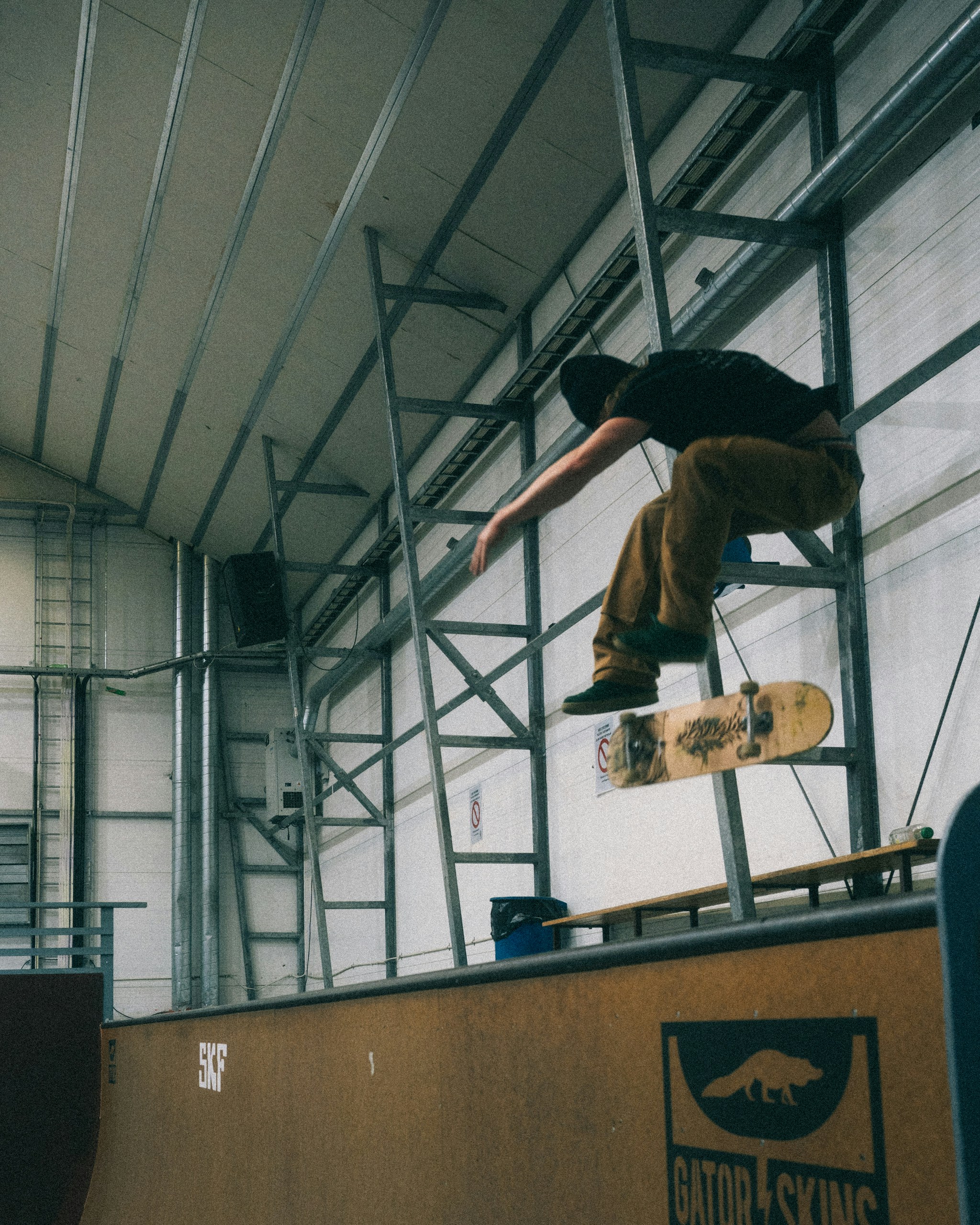 Skateboarder performing a trick in an indoor skatepark