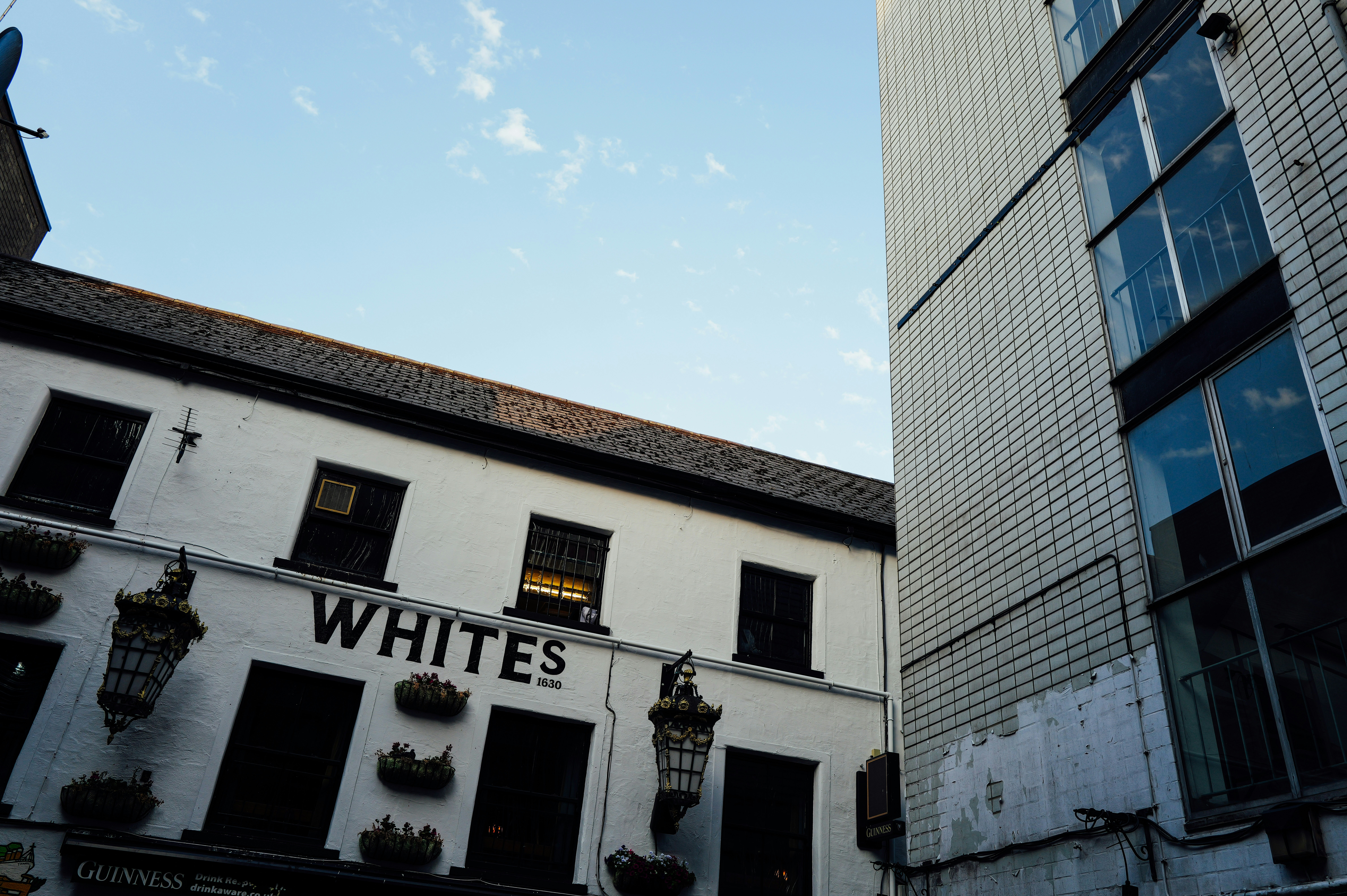 White building with "whites" sign under blue sky