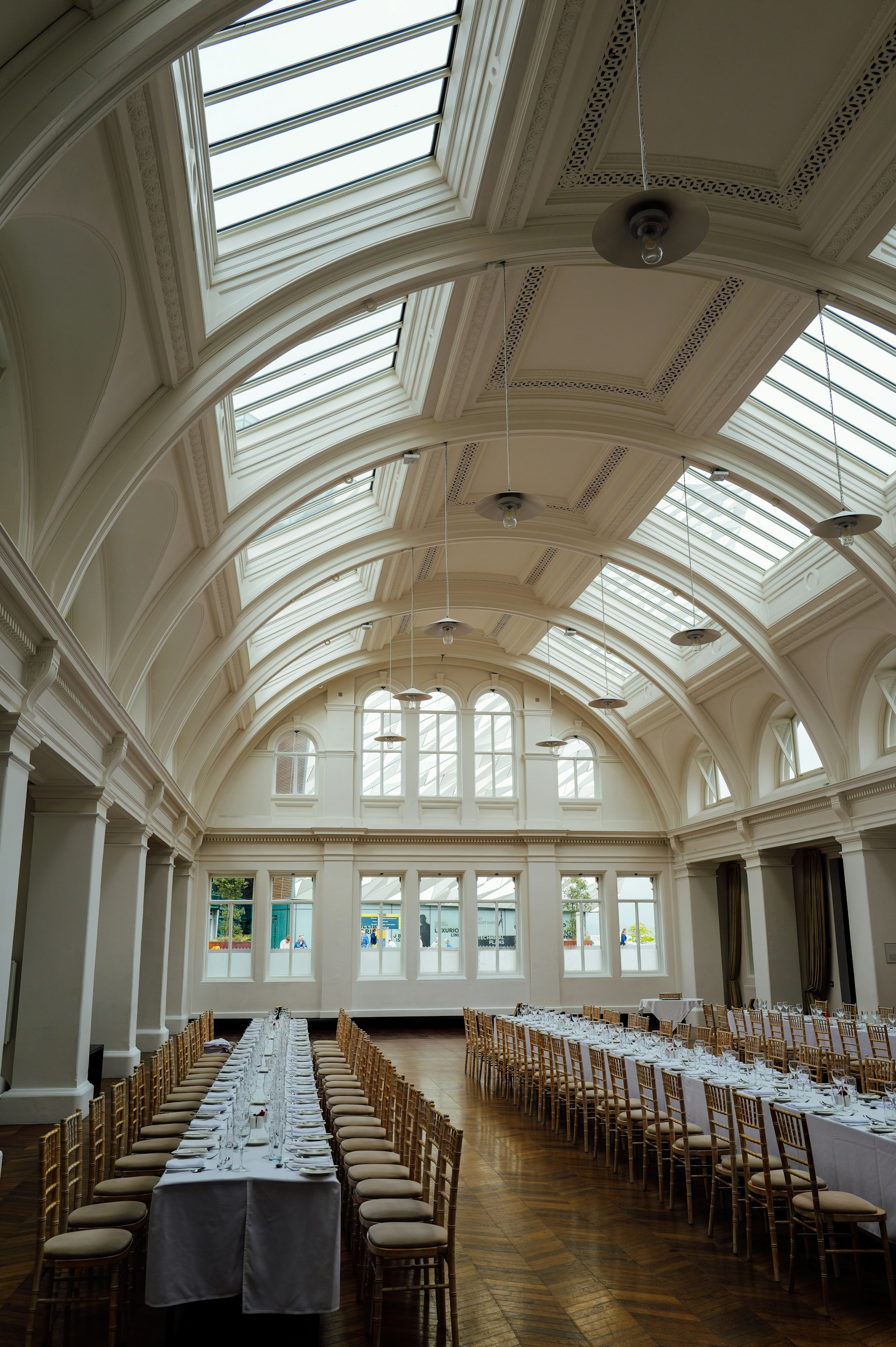 Elegant banquet hall with long tables and chairs.