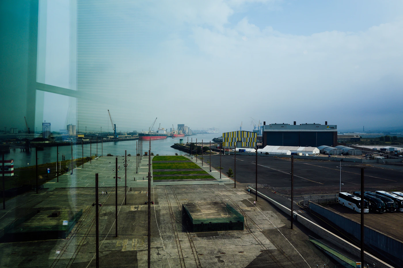 Industrial port with a large docked ship and tall cranes, illustrating the maritime setting that shaped the two-part LHWCA test
