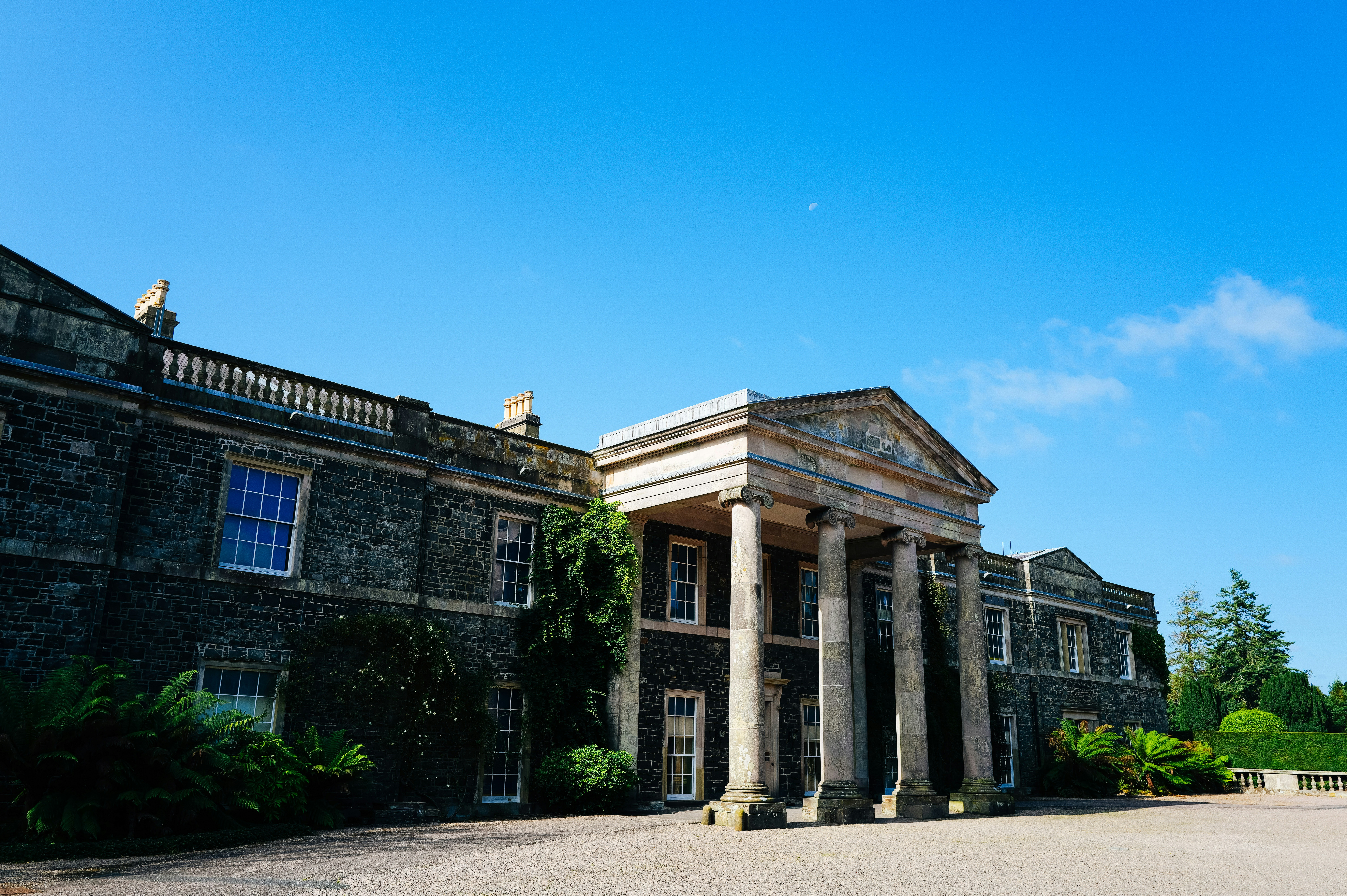 Grand stone building with large columns and blue sky