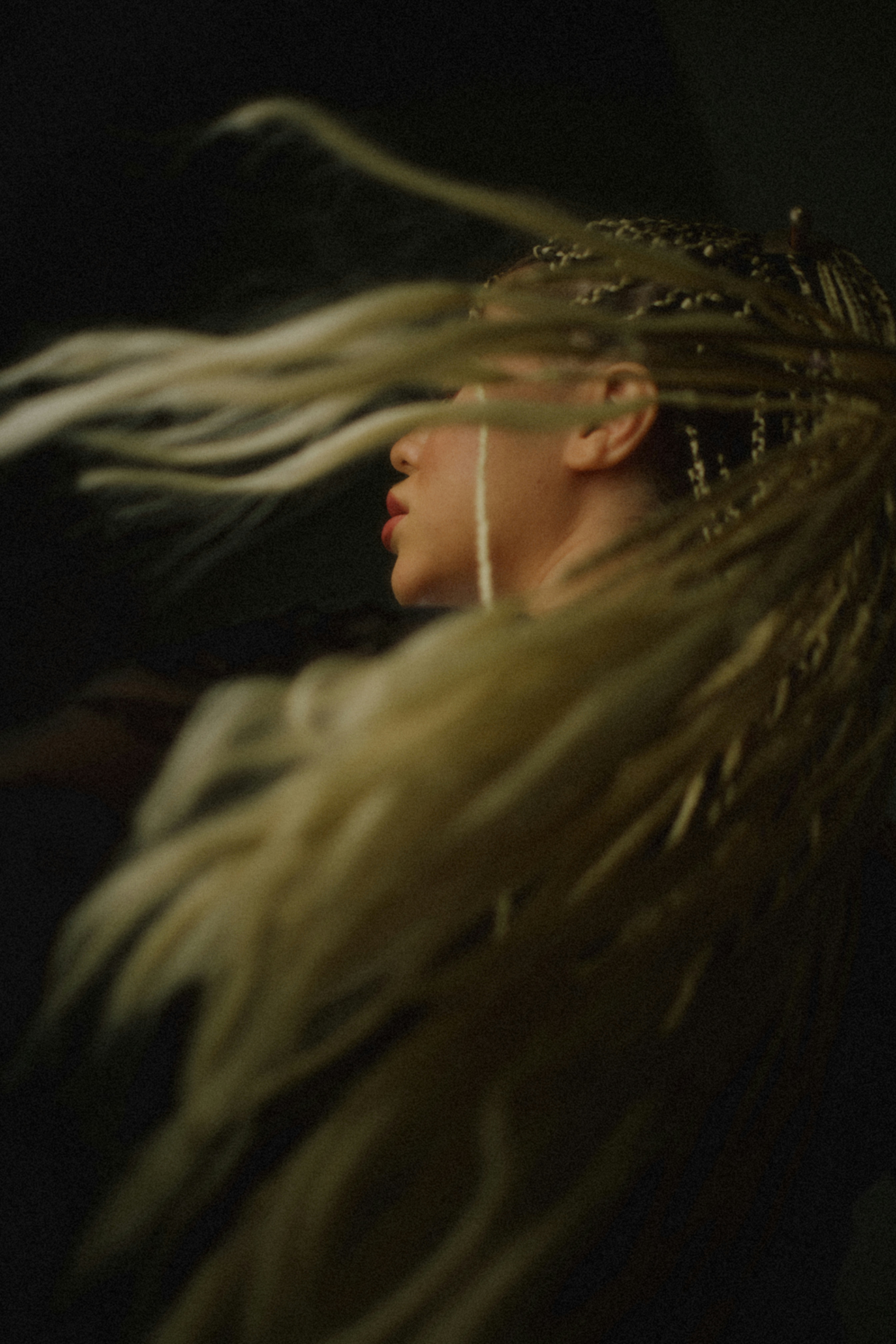 Woman with long blonde hair blowing in wind