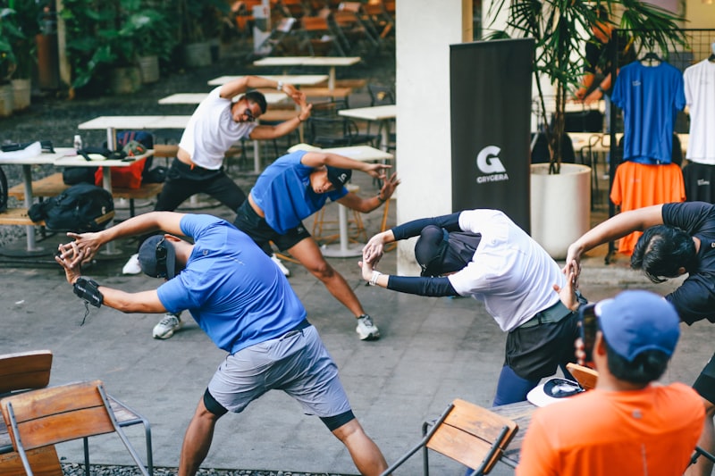 Group of pickleball players stretching outdoors before play
