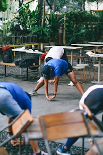 Group stretching outdoors near tables and chairs