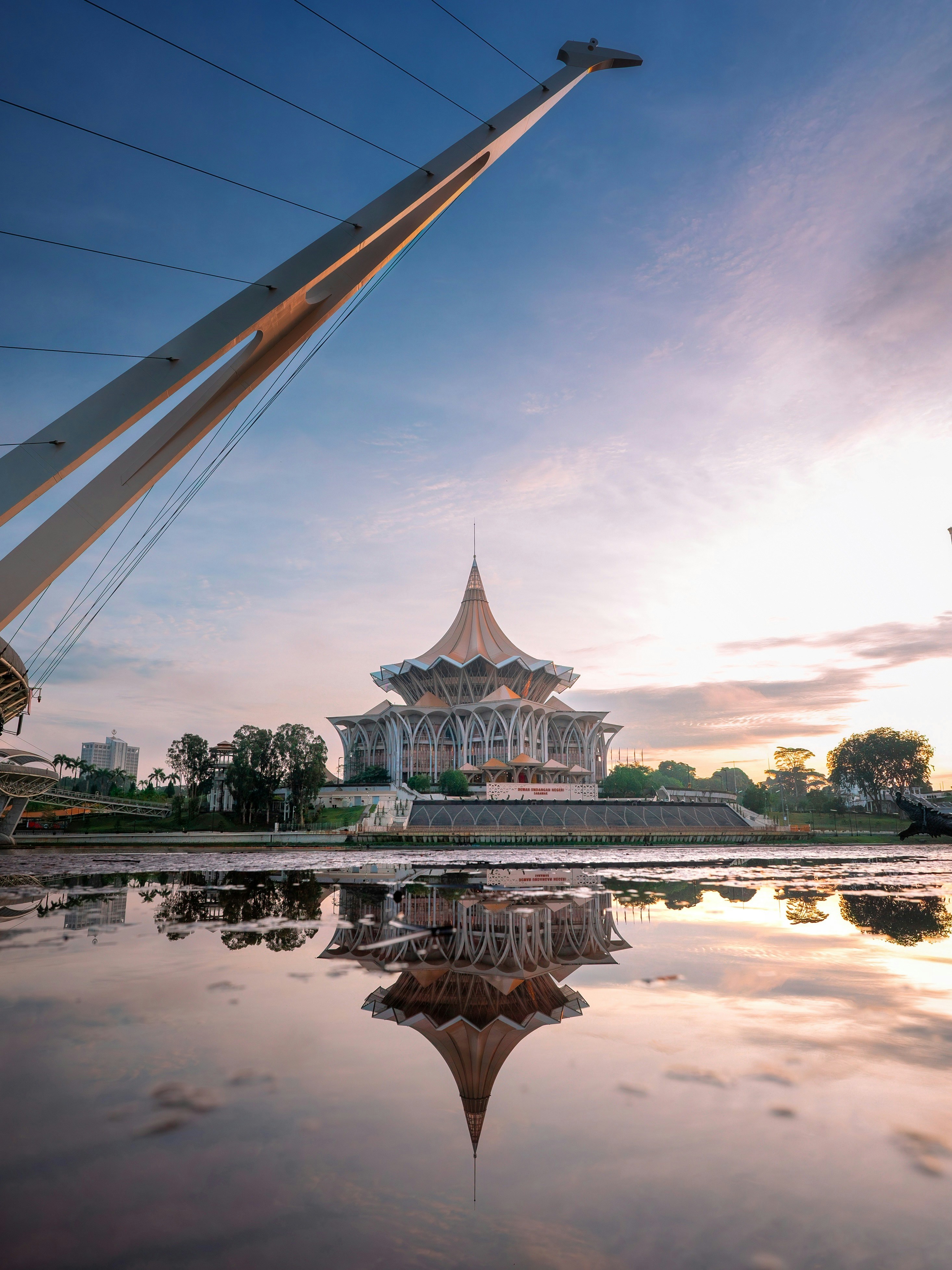 Building reflected in water at sunrise