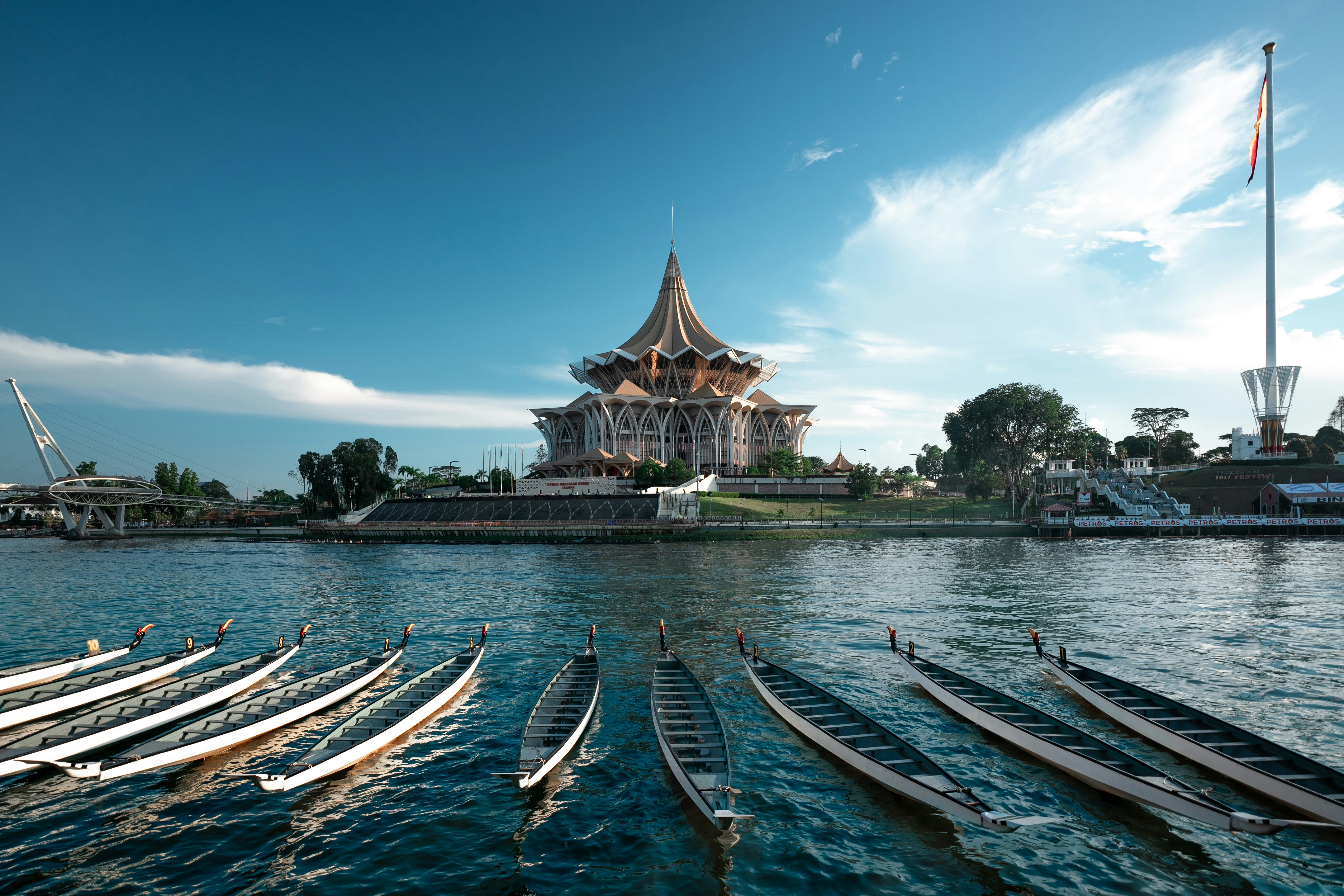Boats on river with distinctive building in background