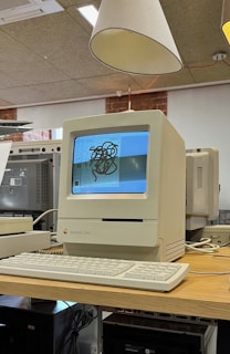 Vintage macintosh computer with keyboard on-screen drawing