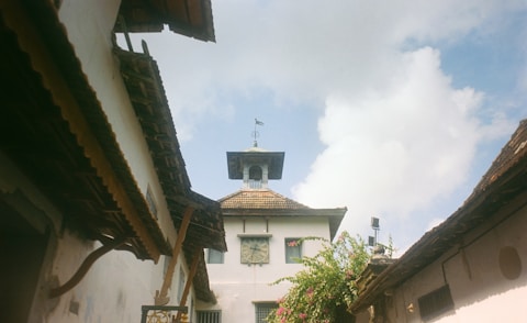 White tower with open windows against cloudy sky