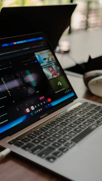 Laptop screen shows a video conference with multiple participants.