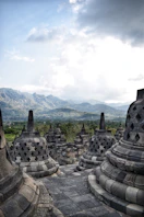 Ancient stupas with mountains in the background