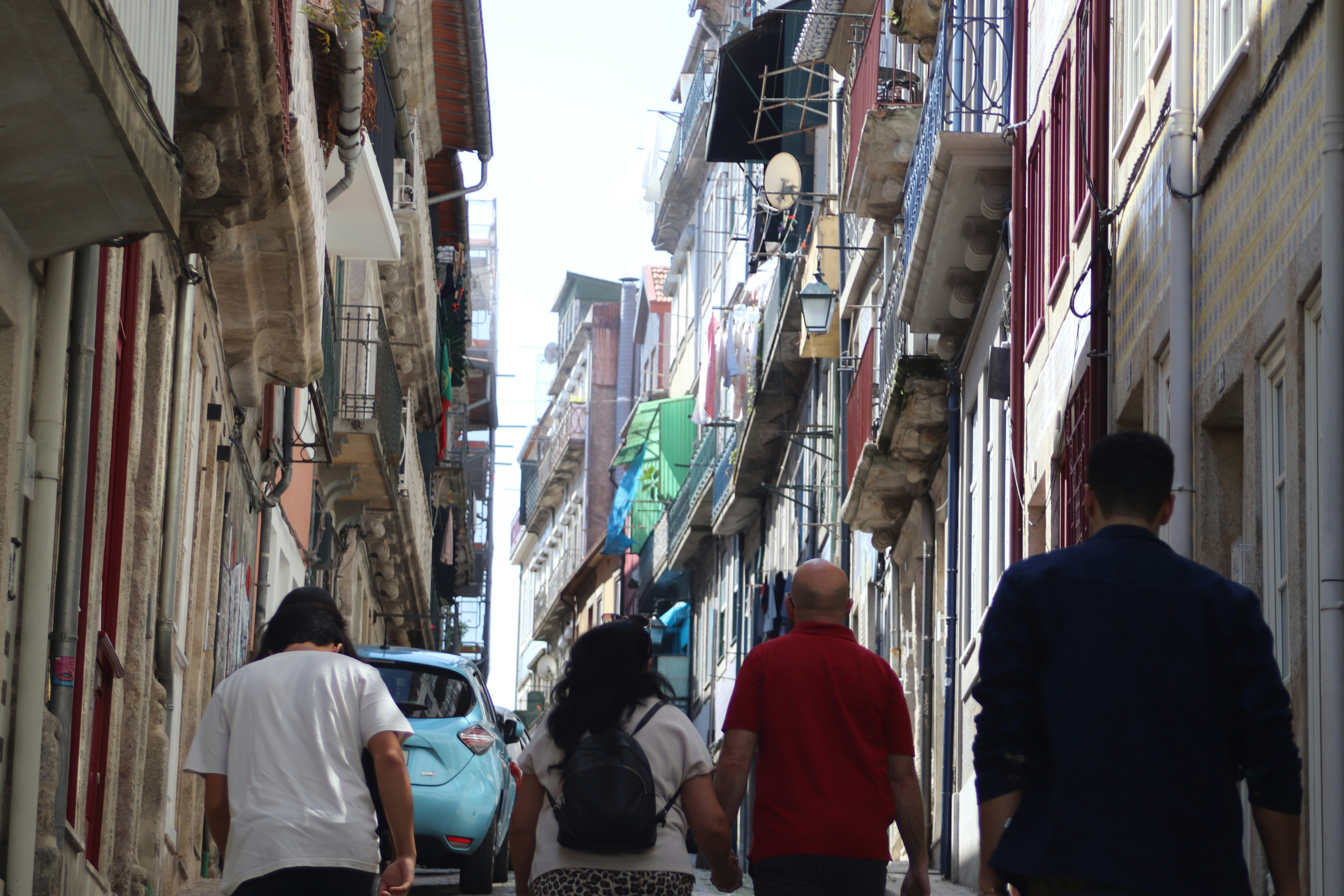 People walking down a narrow european street.