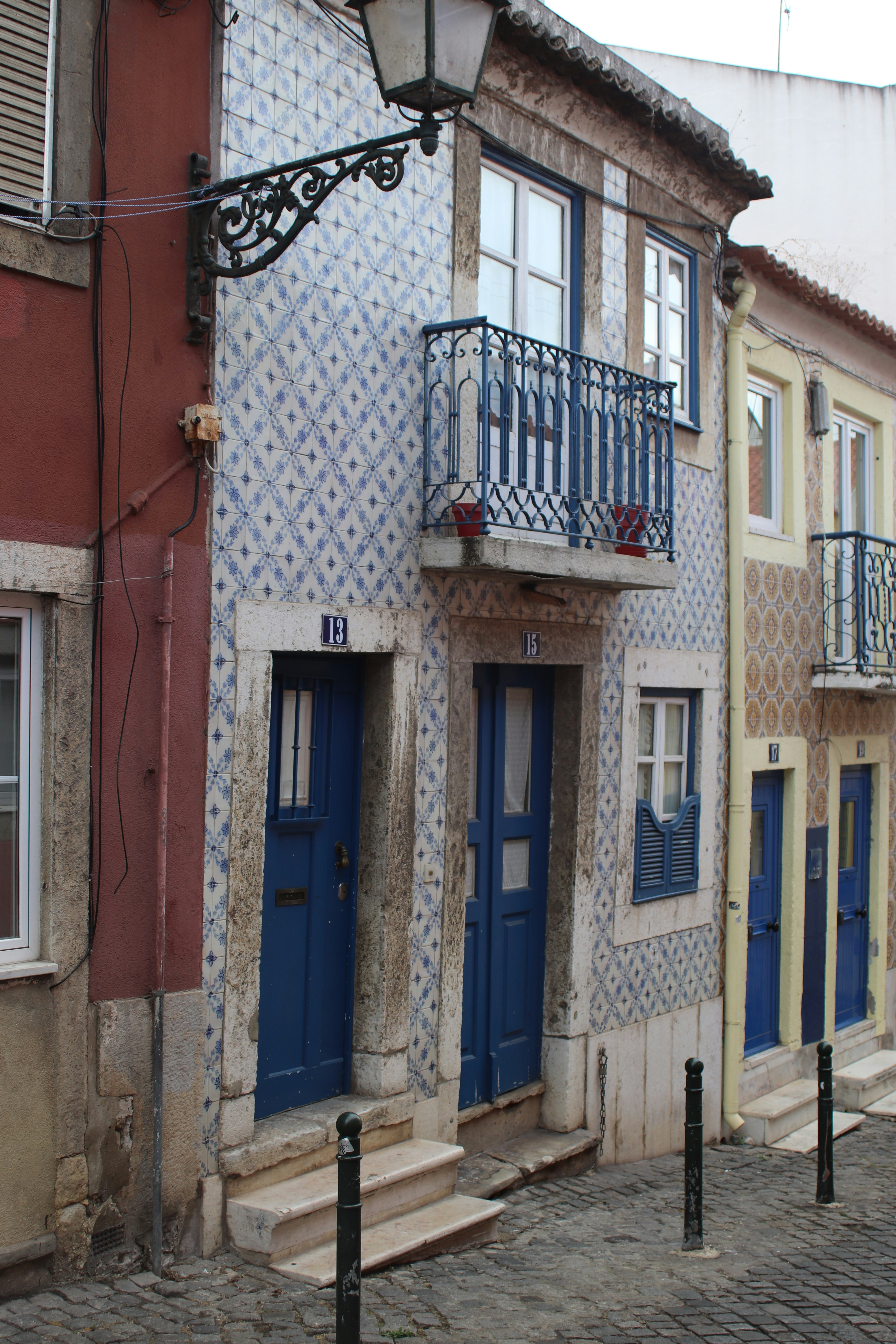 Traditional tiled buildings with blue doors on cobblestone street