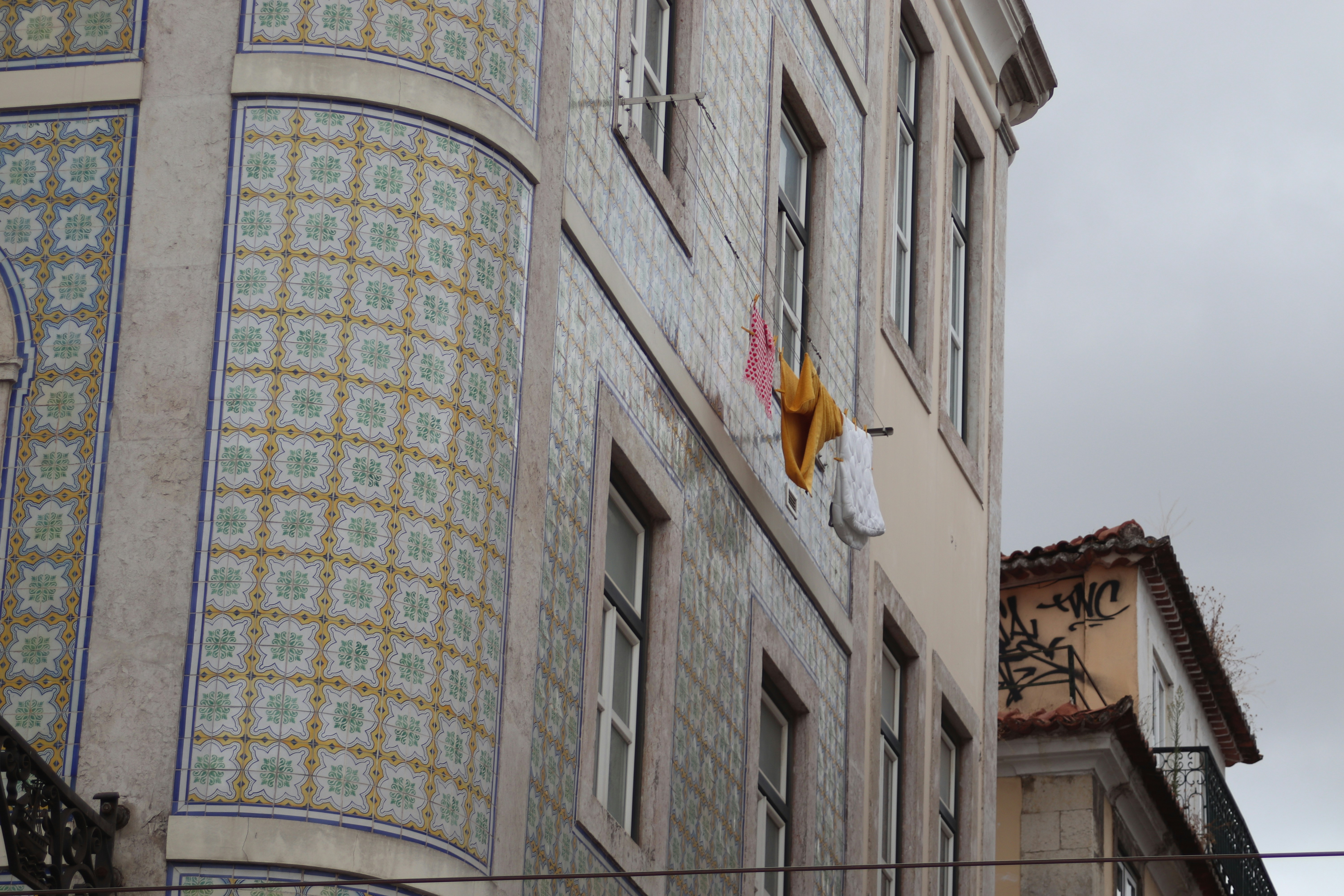 Building facade with patterned tiles and laundry hanging