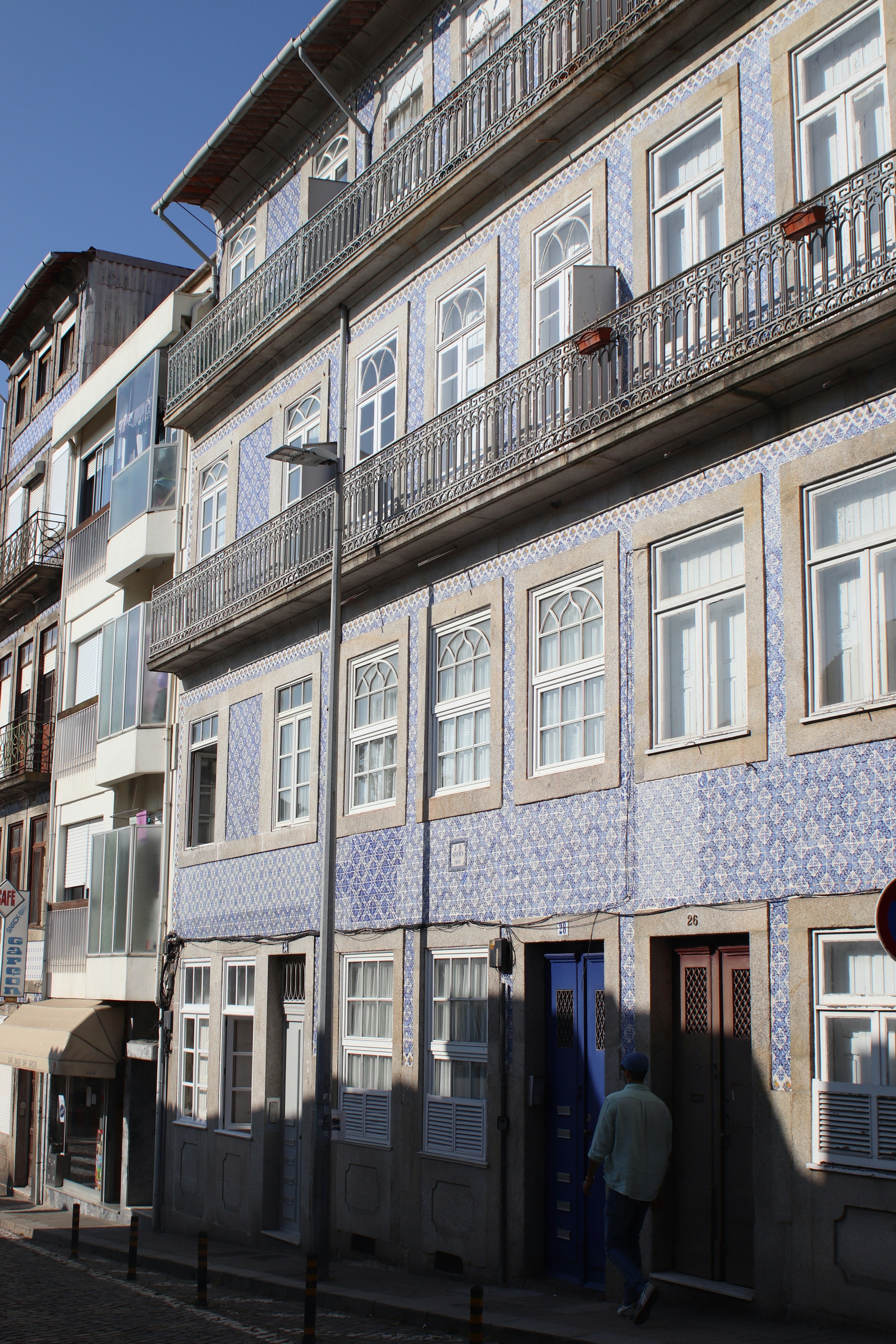 Ornate tiled building facade with balconies and windows.