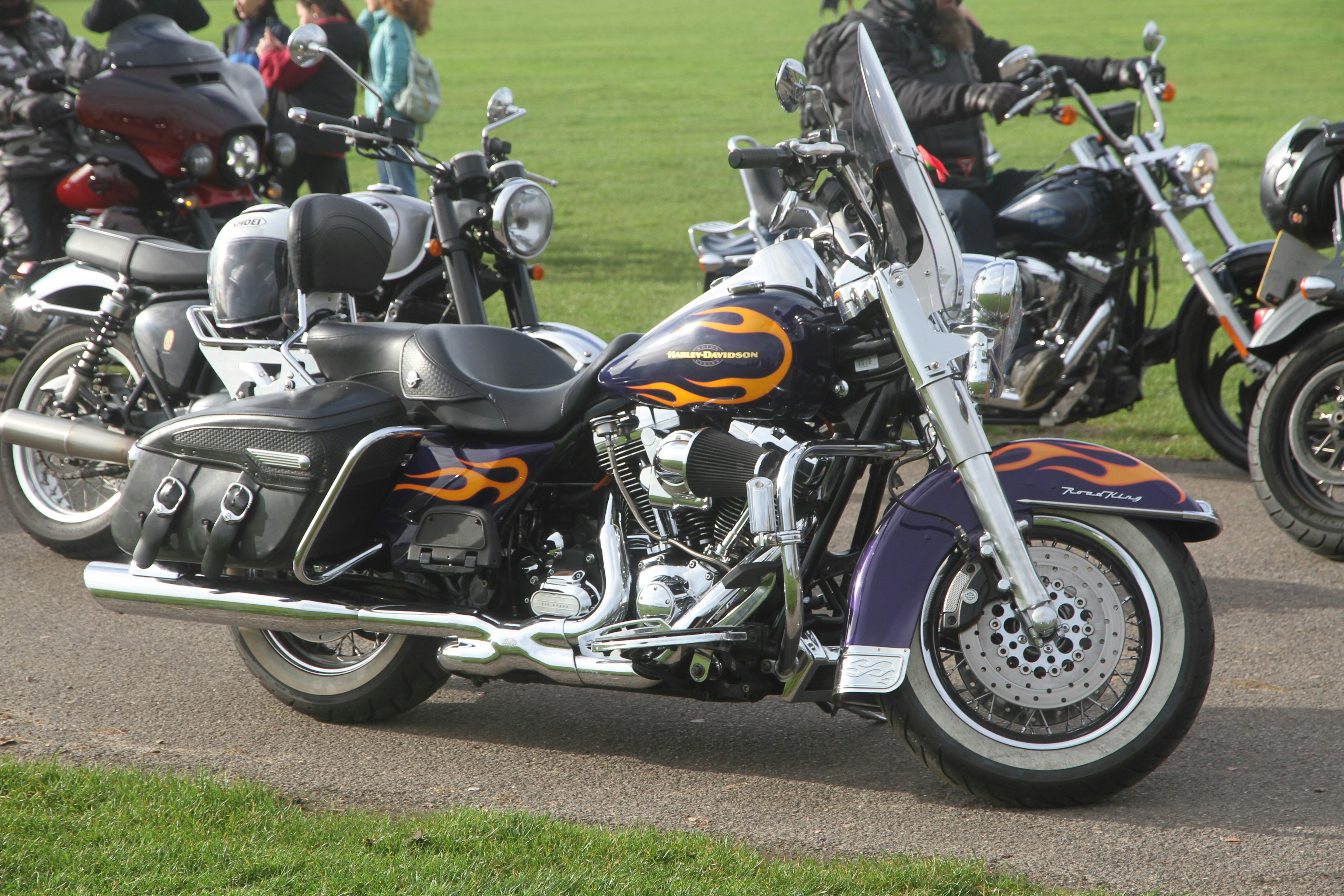 Purple motorcycle with orange flames parked outside