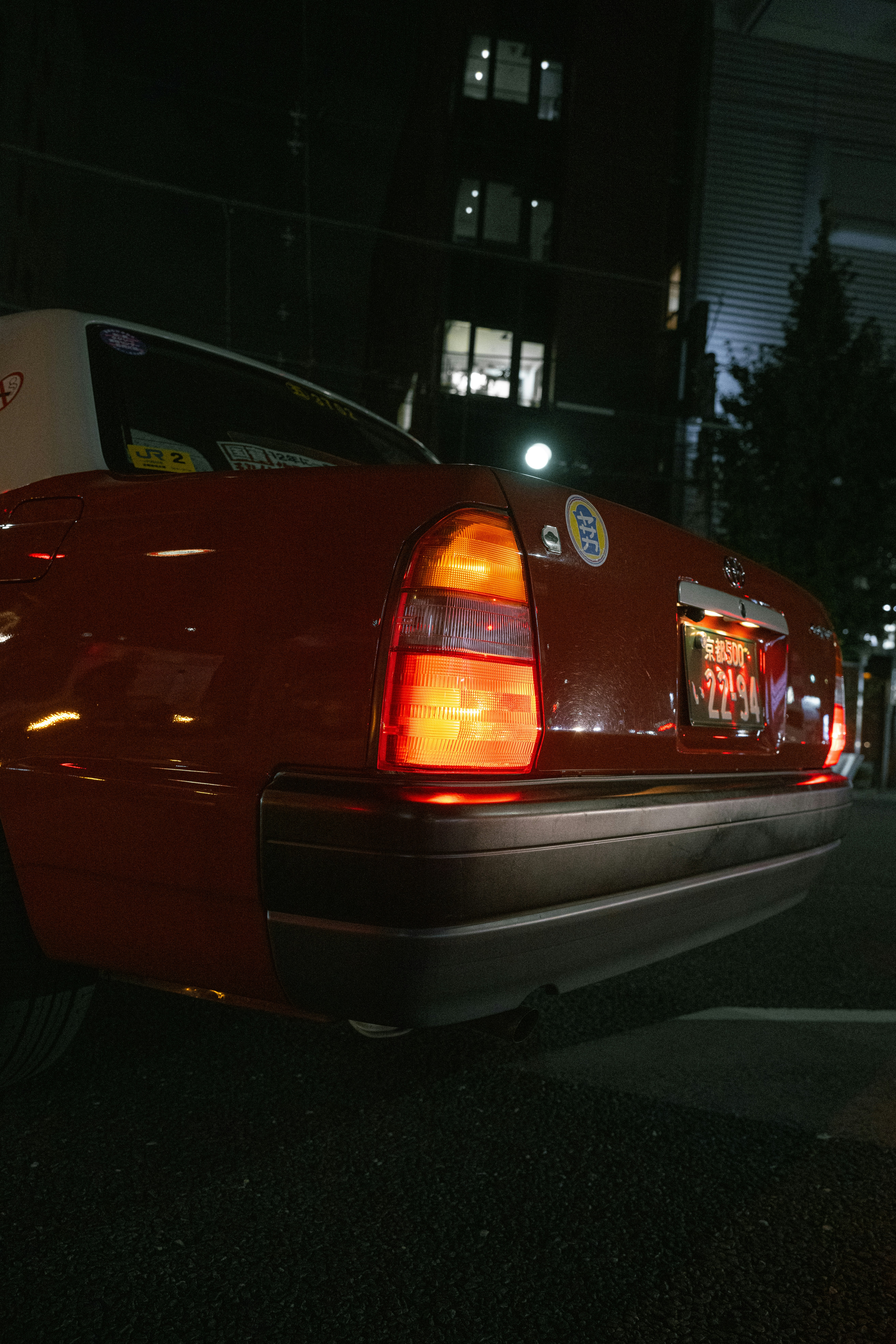 Red taxi taillight glowing at night