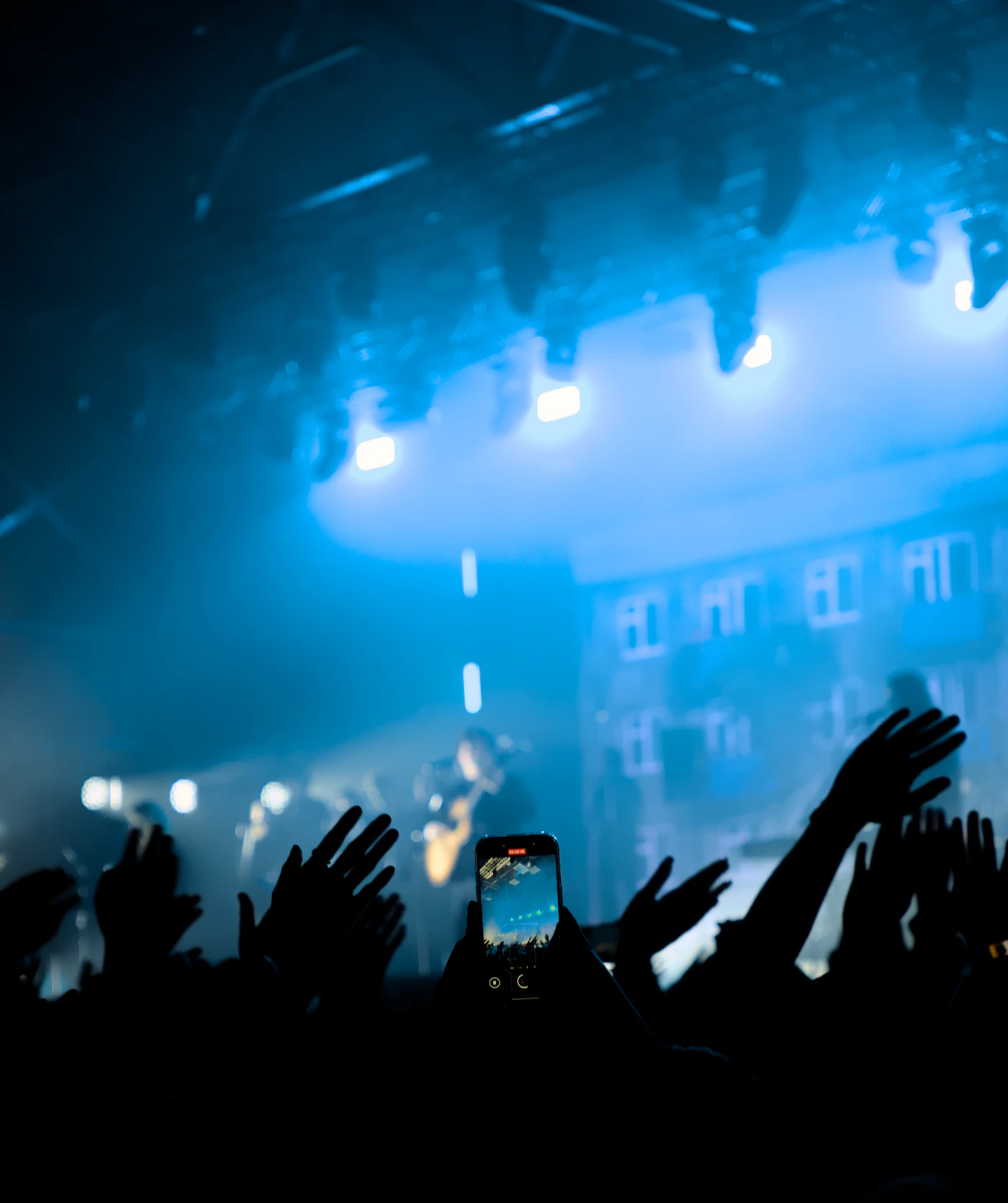 Crowd at a concert with hands raised