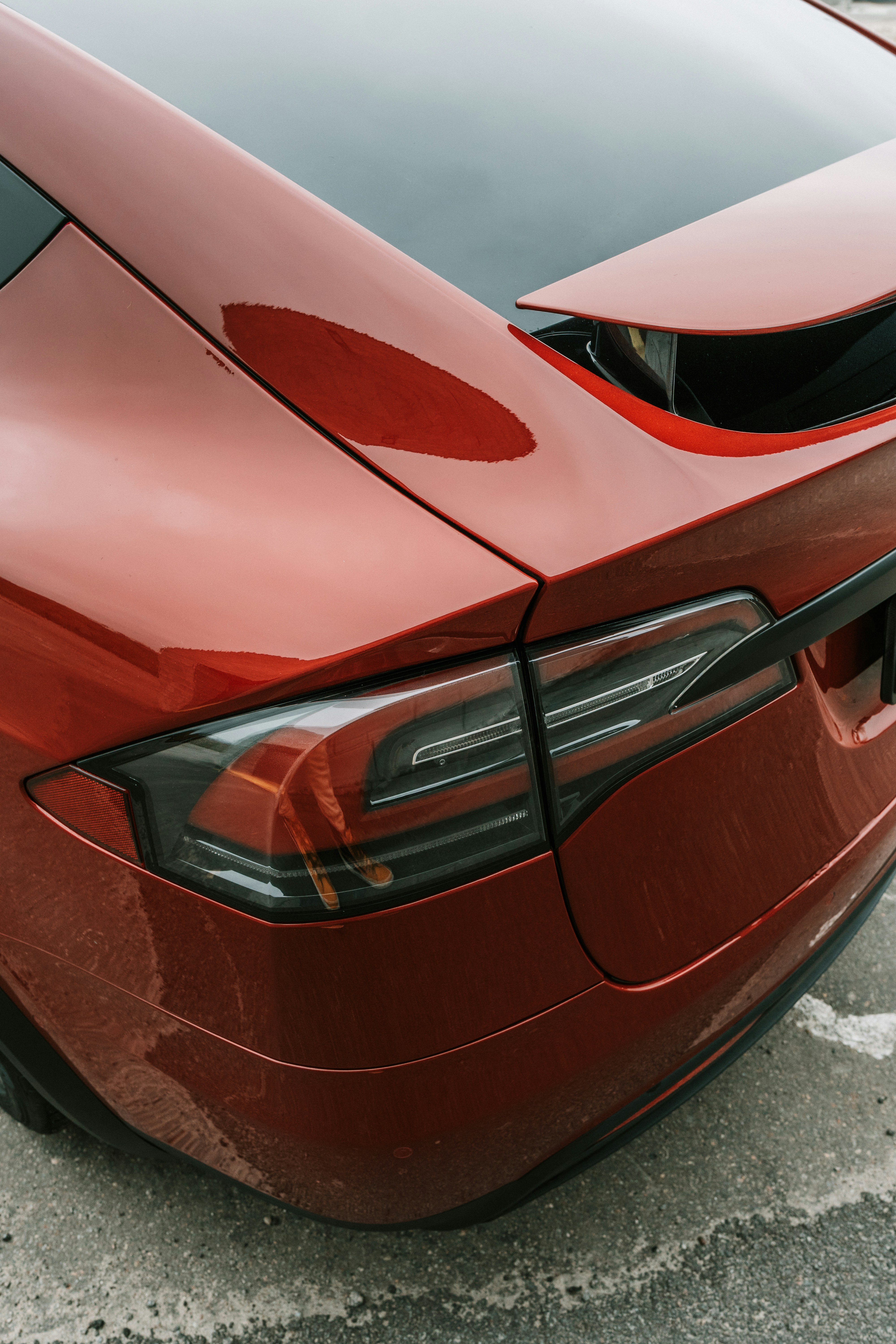 Close-up of a red car's taillight and trunk