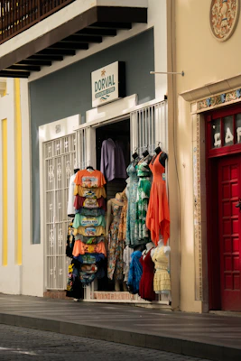 Colorful clothing displayed outside a shop entrance