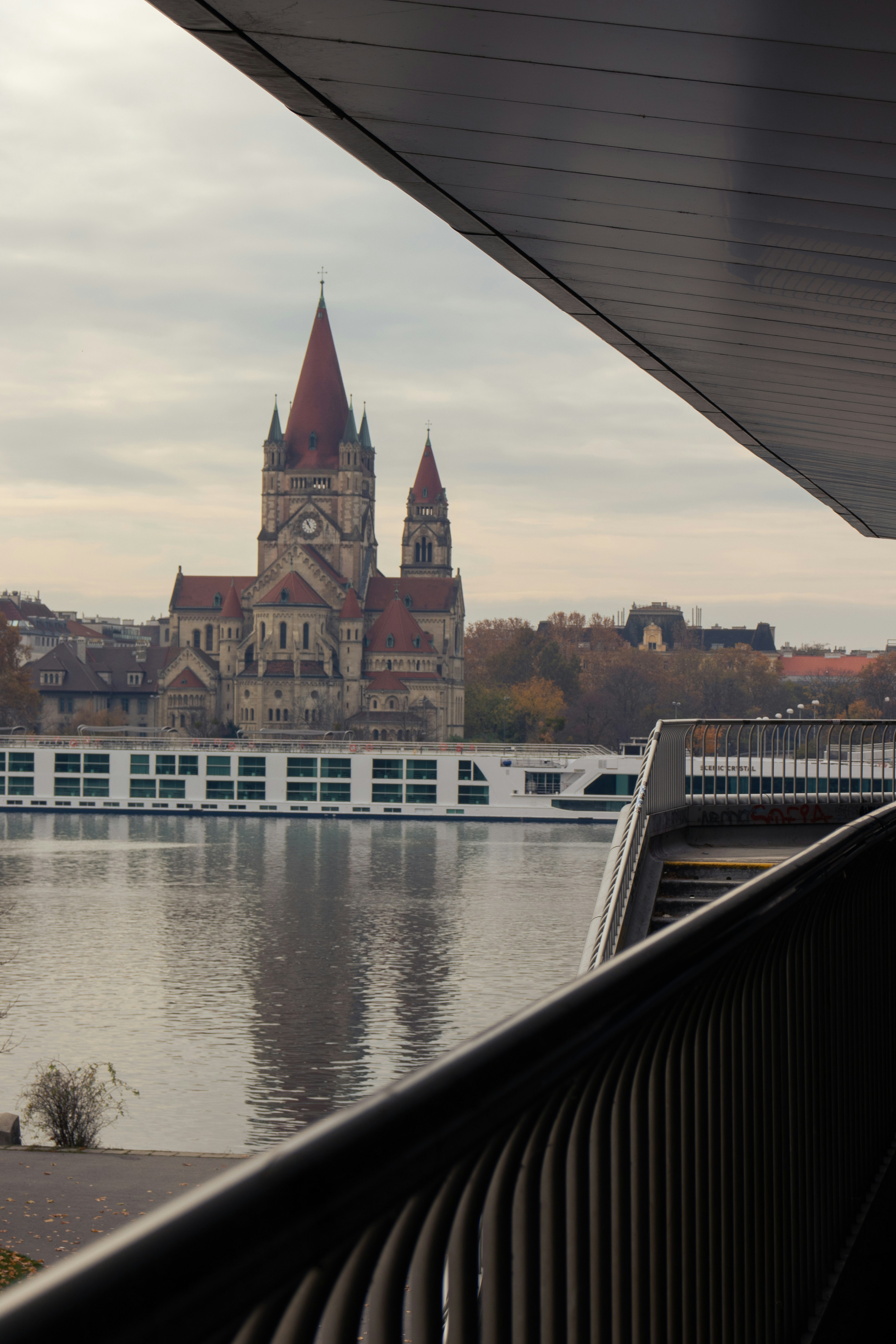 Church with red roof overlooking a river