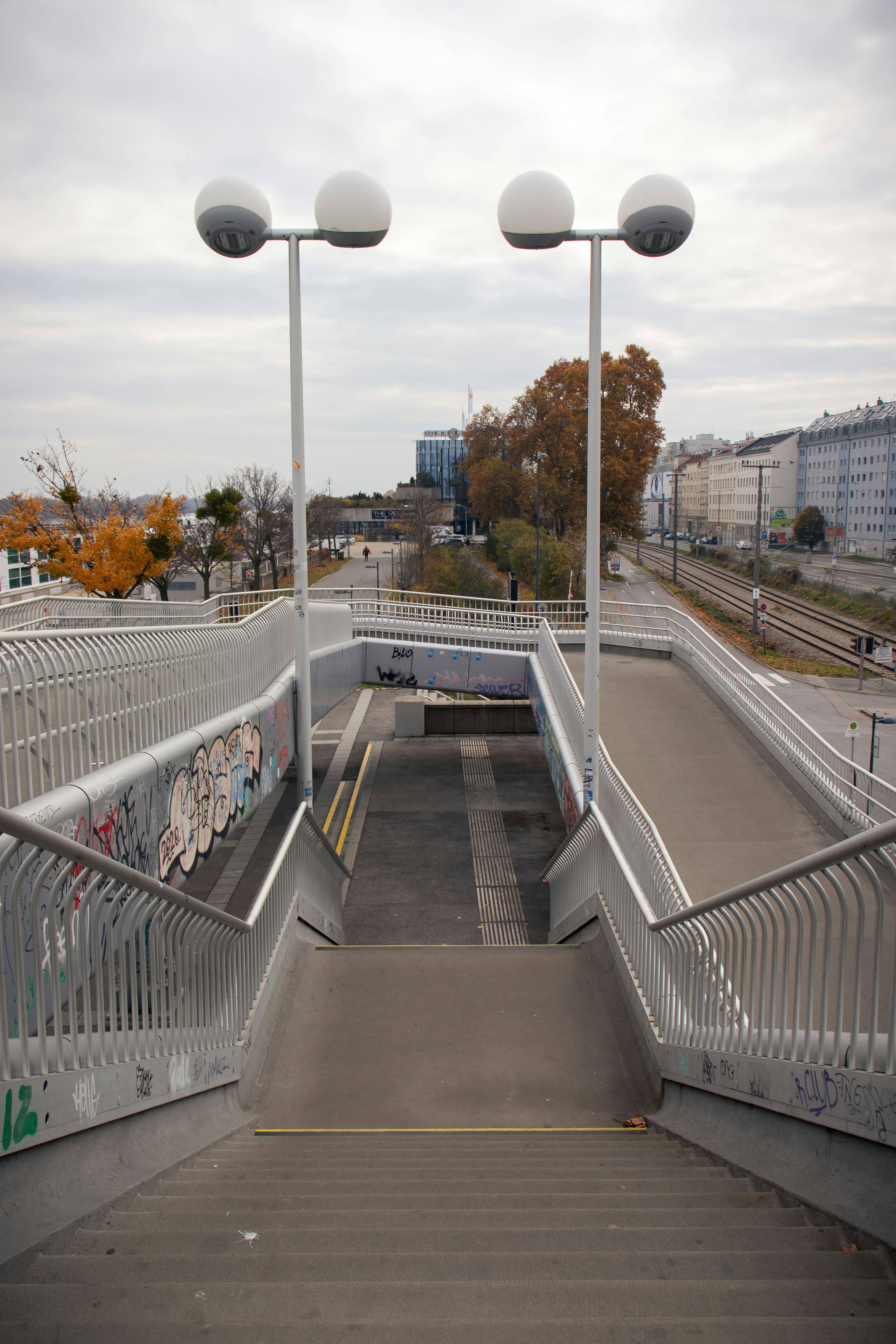 Stairway leading down to an underpass with streetlights.