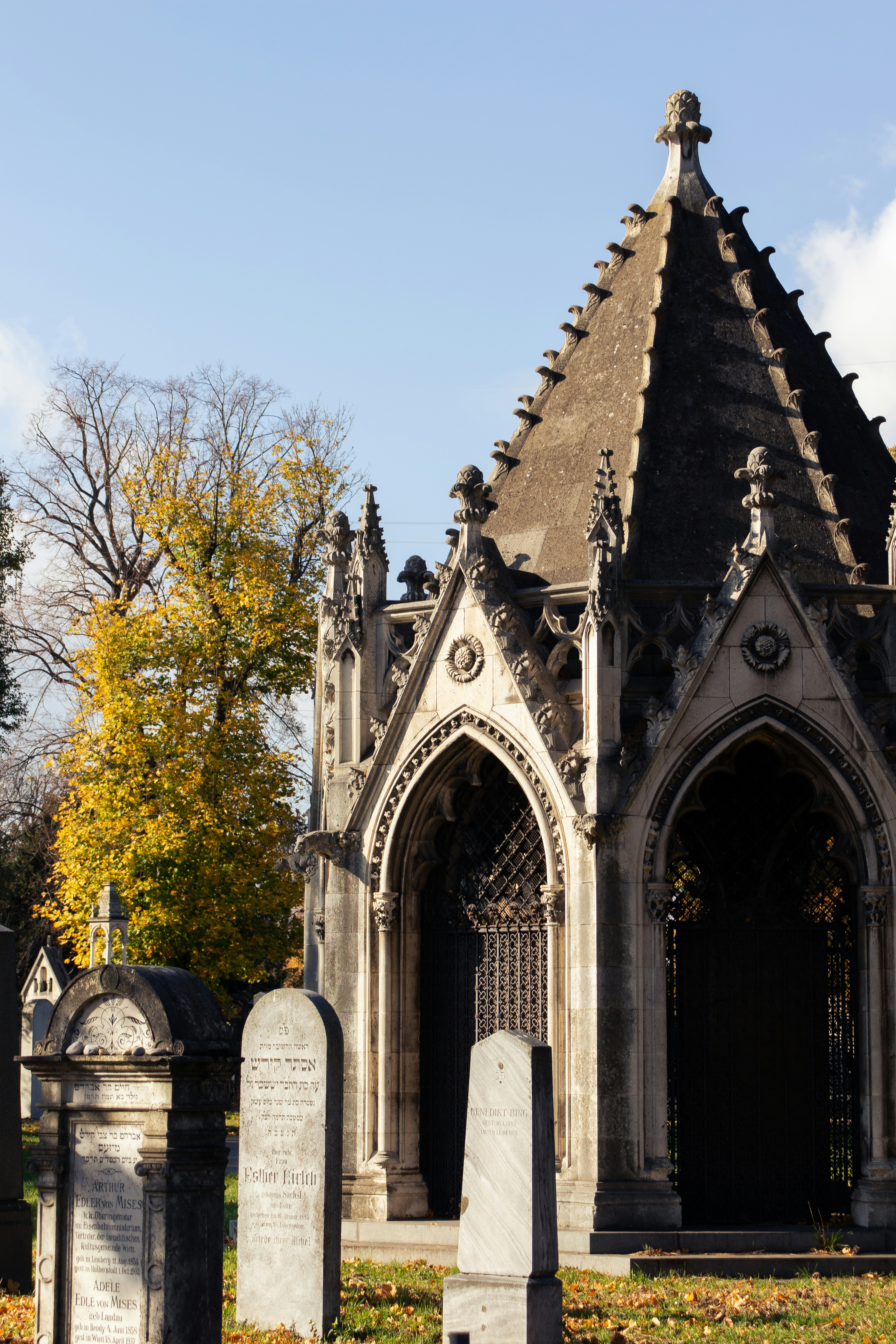 Gothic mausoleum with tombstones in autumn
