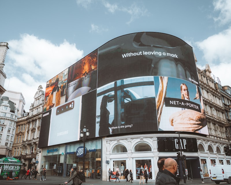 Large curved building facade covered with digital advertising displays