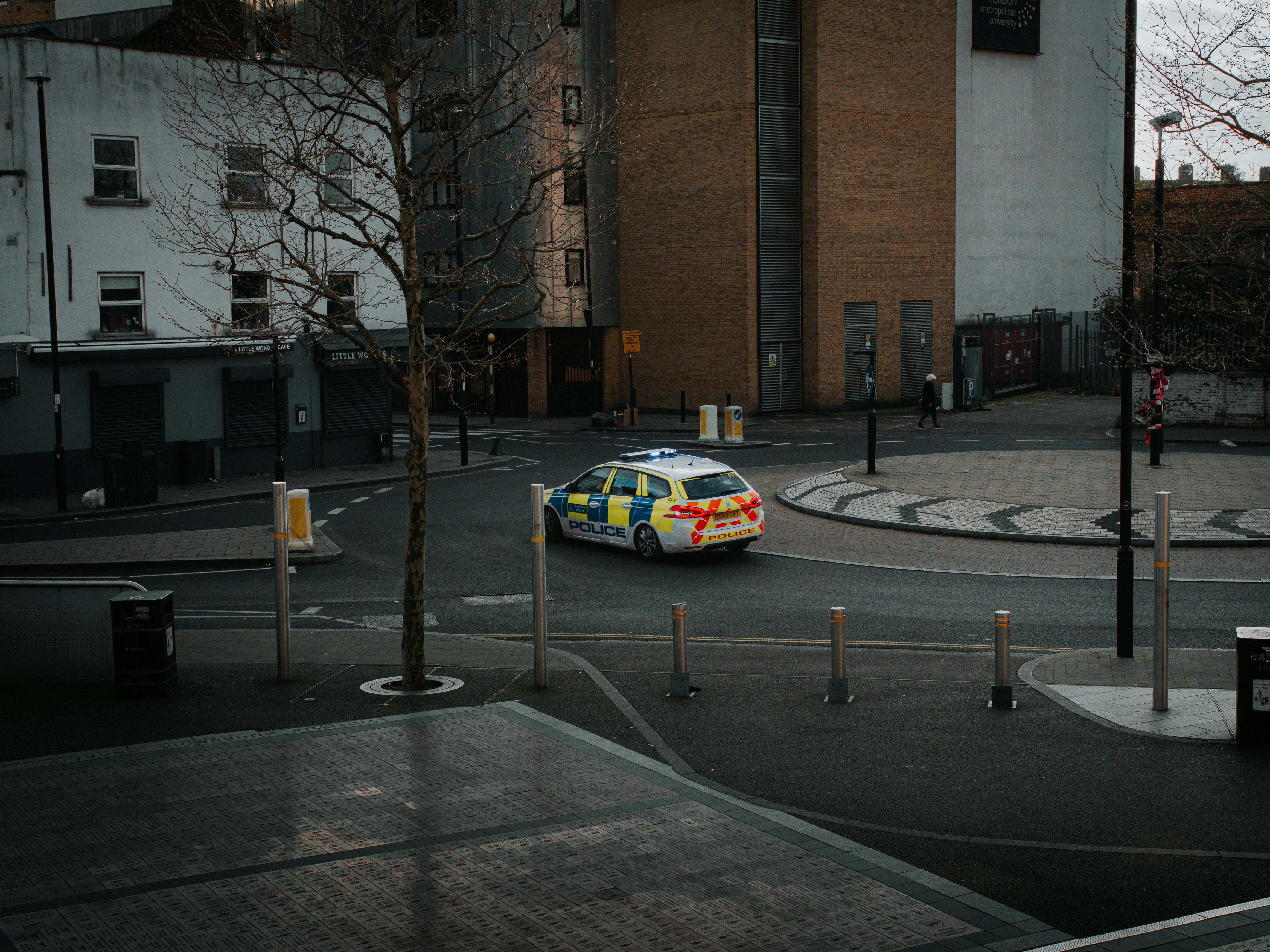 Police car driving around a city intersection.