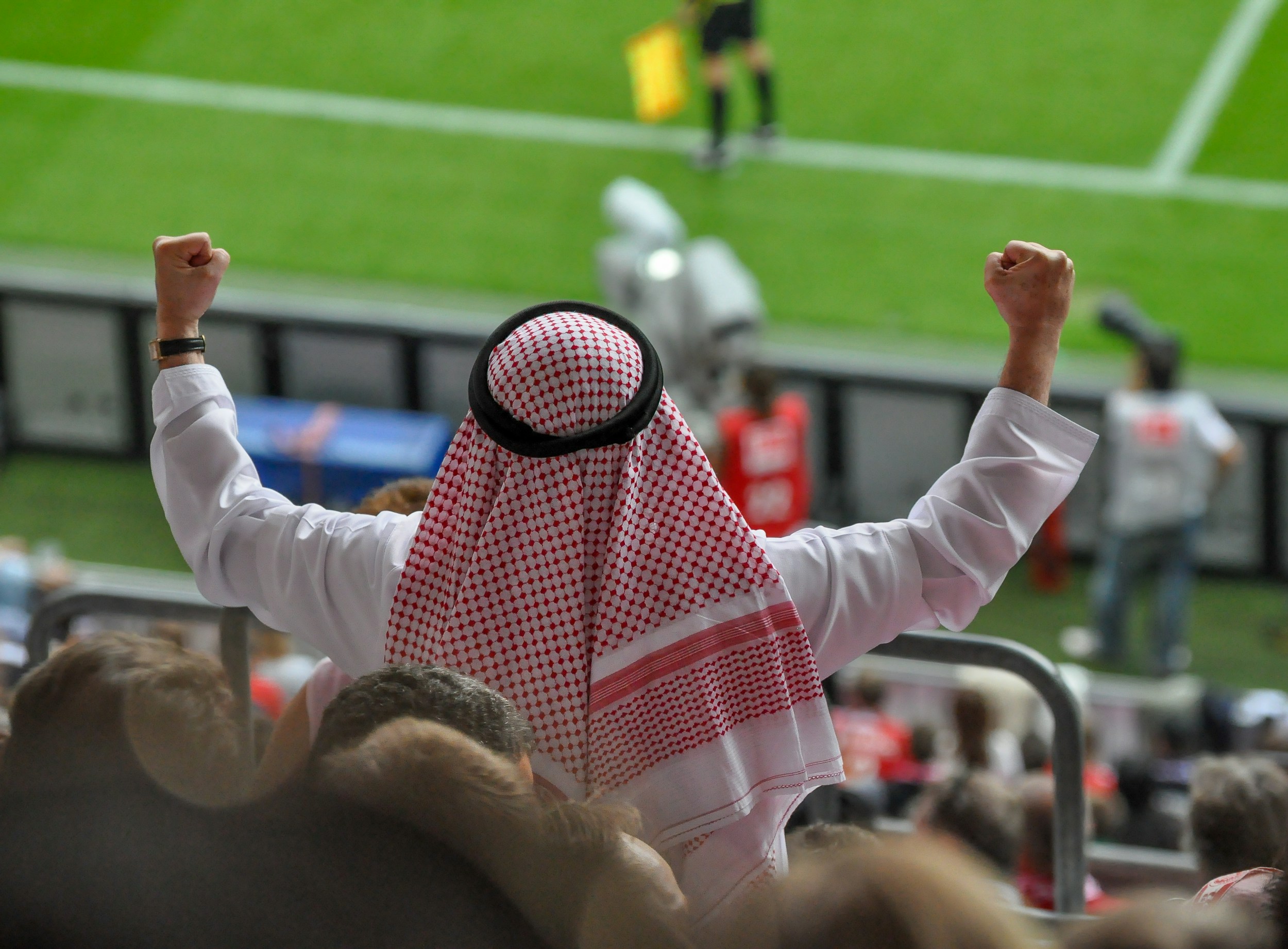 footballer celebrating goal stadium