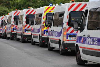 A line of french police vans on a street
